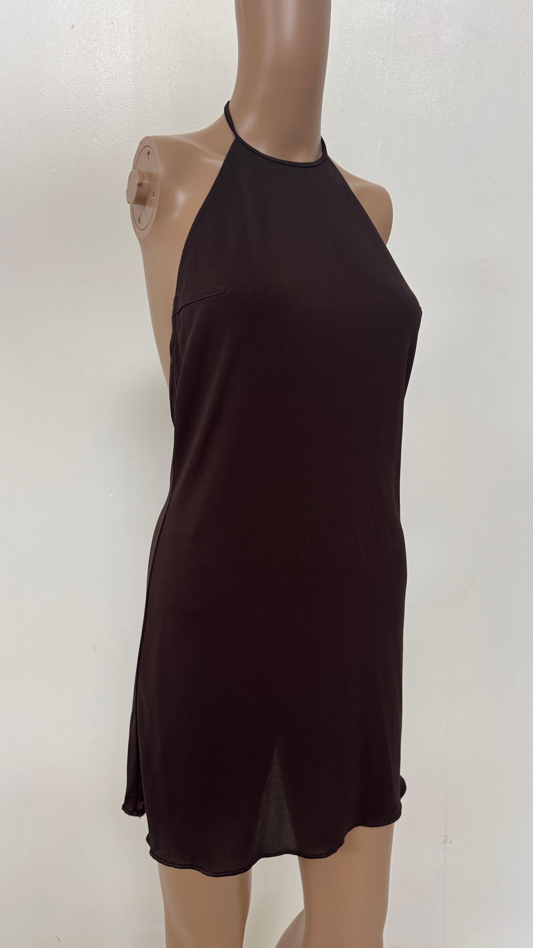 A sleek and sensual 1990s halter mini dress by Future Ozbek, crafted in a rich chocolate brown stretch fabric with an ultra-minimalist silhouette. This backless design ties at the neck and softly drapes over the body, creating a fluid and subtly