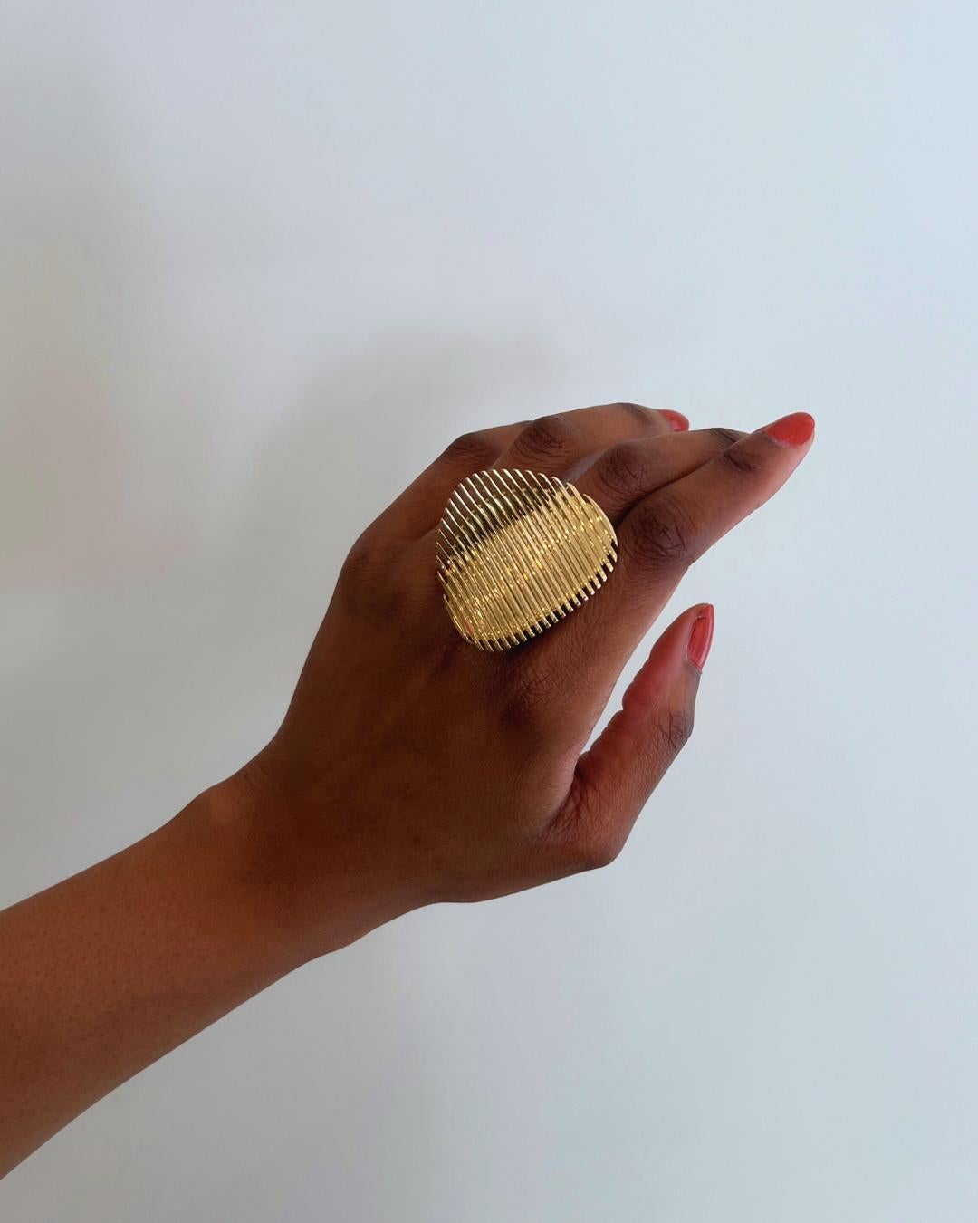 A rare and collectible ring. An 18 karat gold Lamellae, limited edition cocktail ring, by the award-winning, postmodern, futurist architect, Zaha Hadid, for Georg Jensen. Stamped © Zaha Hadid, Georg Jensen maker's mark, 750, 55, 1623 A, 6/25. Ring