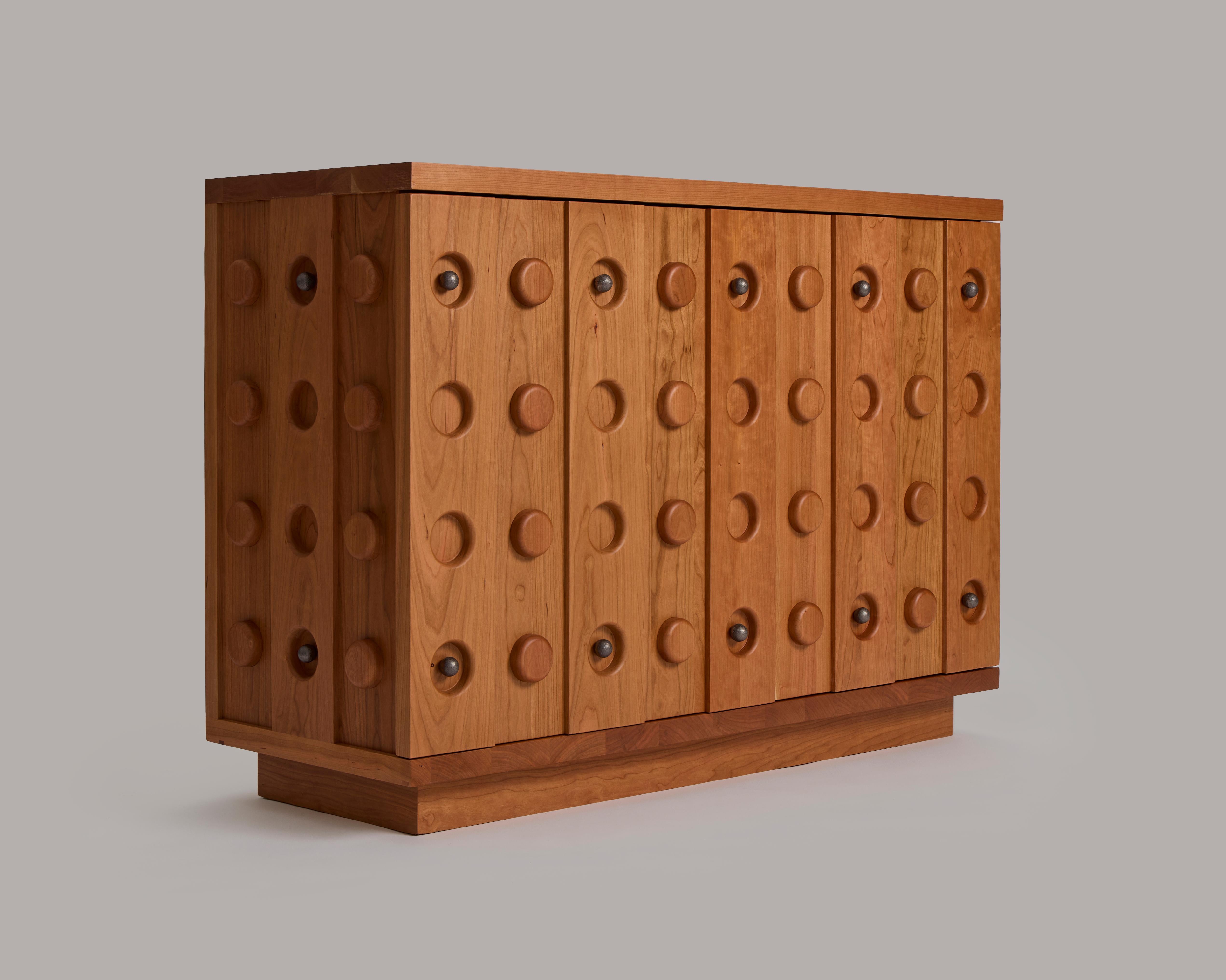 Inspired by cabinets with graphic and metal details from the 1930s — as well as the candy buttons we all remember from our childhood — the Bon Console is meant to stand out in a room. The hardware — 14 perfectly round knobs in stainless steel or