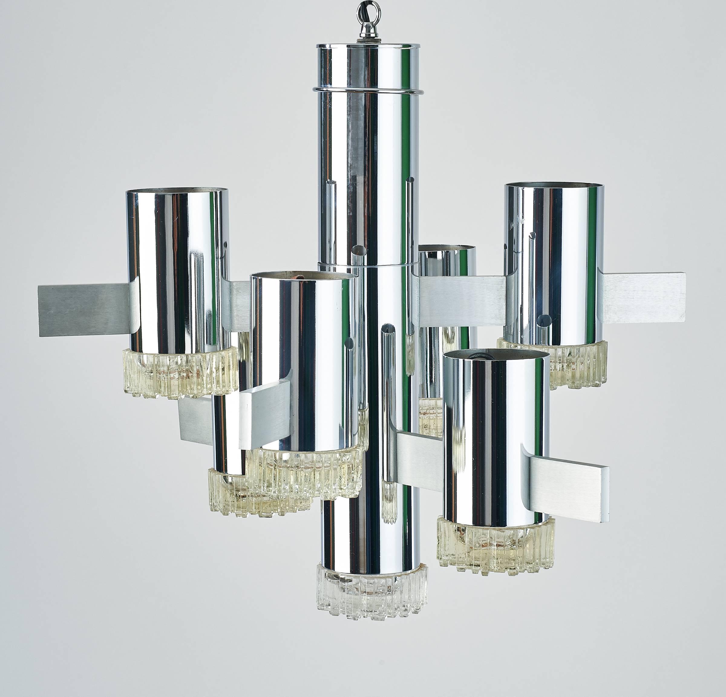 Gaetano Sciolari (1927–1994).

Asymmetrical seven-branch chandelier by Gaetano Sciolari, in chrome with cubist textured glass lenses and contrasting steel mounts.

Rewired for use in the U.S.