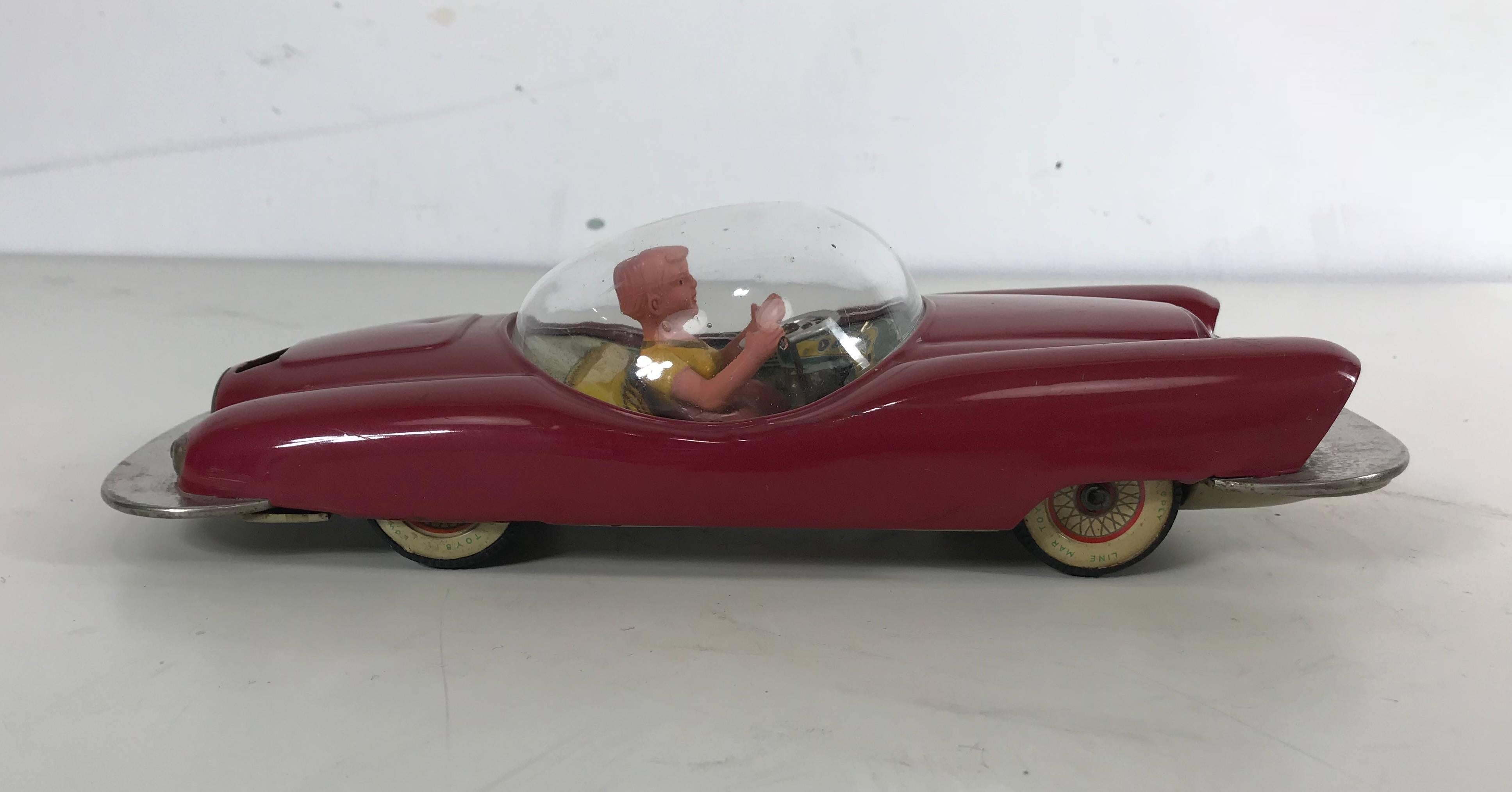 Futuristic Roadster 1956 Japanese tin car complete with acrylic bubble.

This particular car from Line Mar completely captures the 1956 future car concepts and puts it in tin and with a cockpit. The toy looks like it is ready for flight and is in