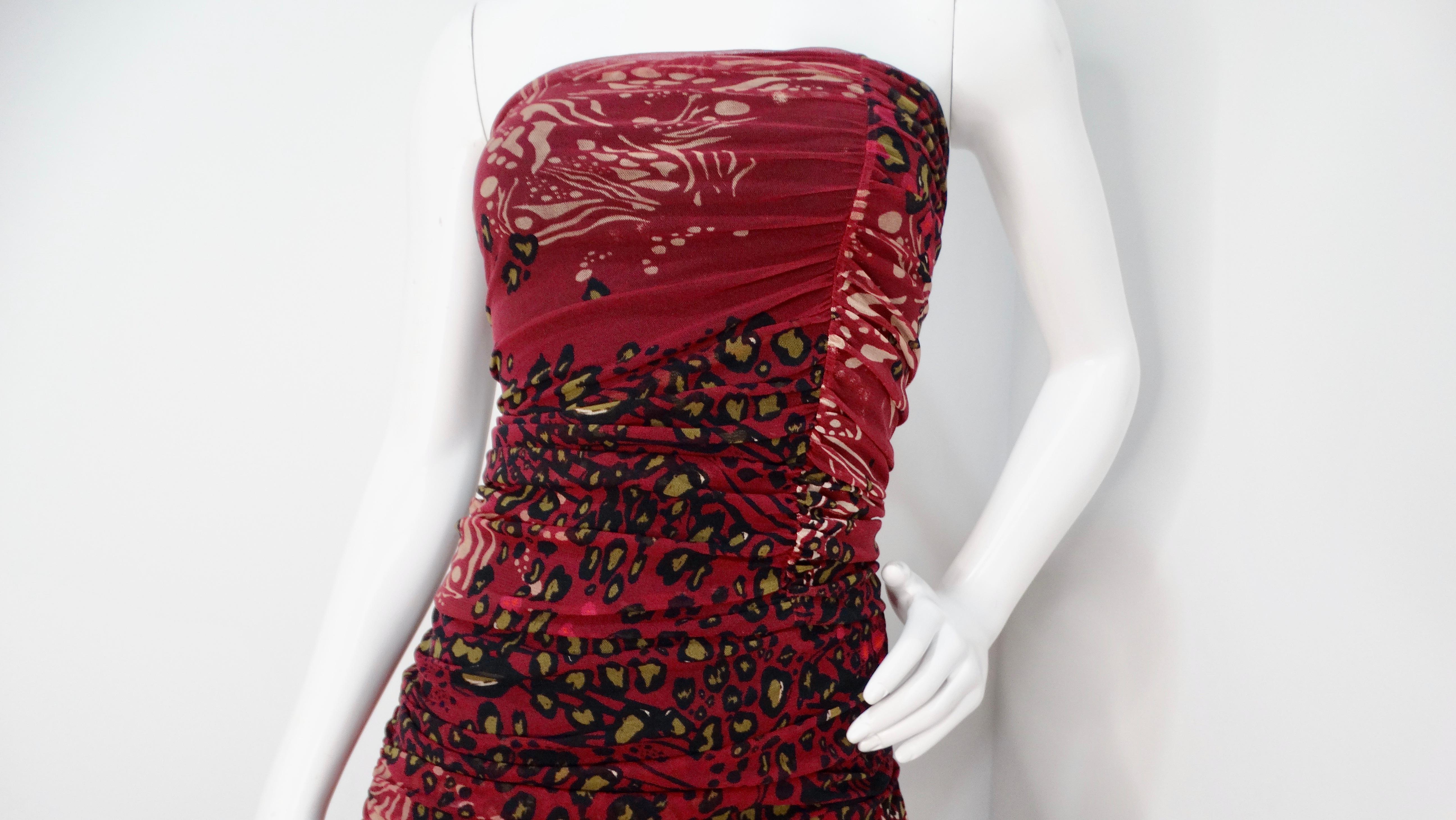 The Fuzzi Burgundy Animal Print Mesh Strapless Midi Dress, meticulously crafted in Italy, is an exquisite fusion of elegance and bold fashion. This captivating dress features a rich burgundy wine color adorned with an array of complementary animal