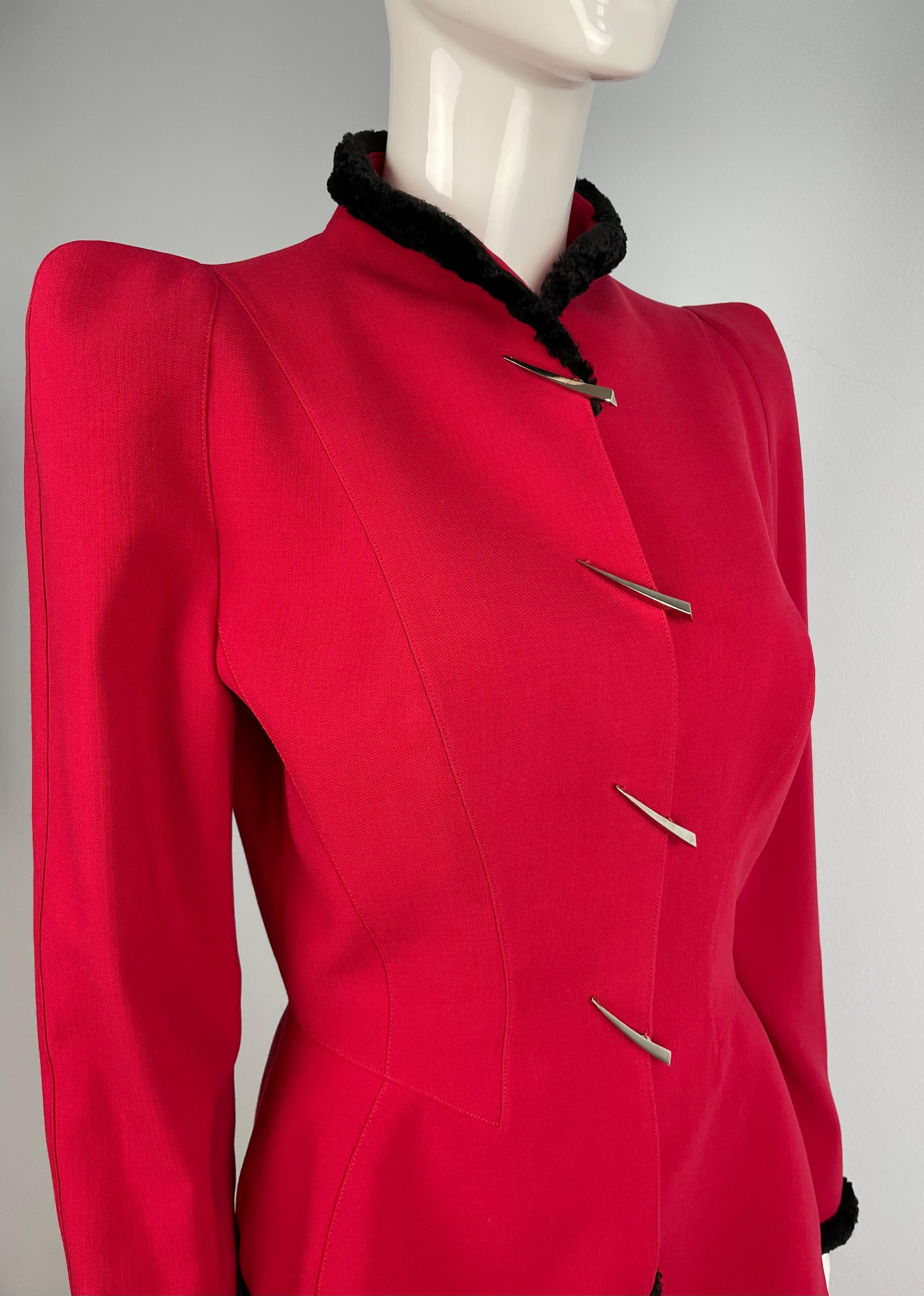 Deep Red Thierry Mugler Skirt Suit from Iconic Fall/Winter 1995 Anniversary Collection. 

Dramatic silhouette with pagoda shoulders.
Faux astrakhan finishing at the collar, cuffs, bottom front and on the sides of the jacket. Famous Mugler’s claw