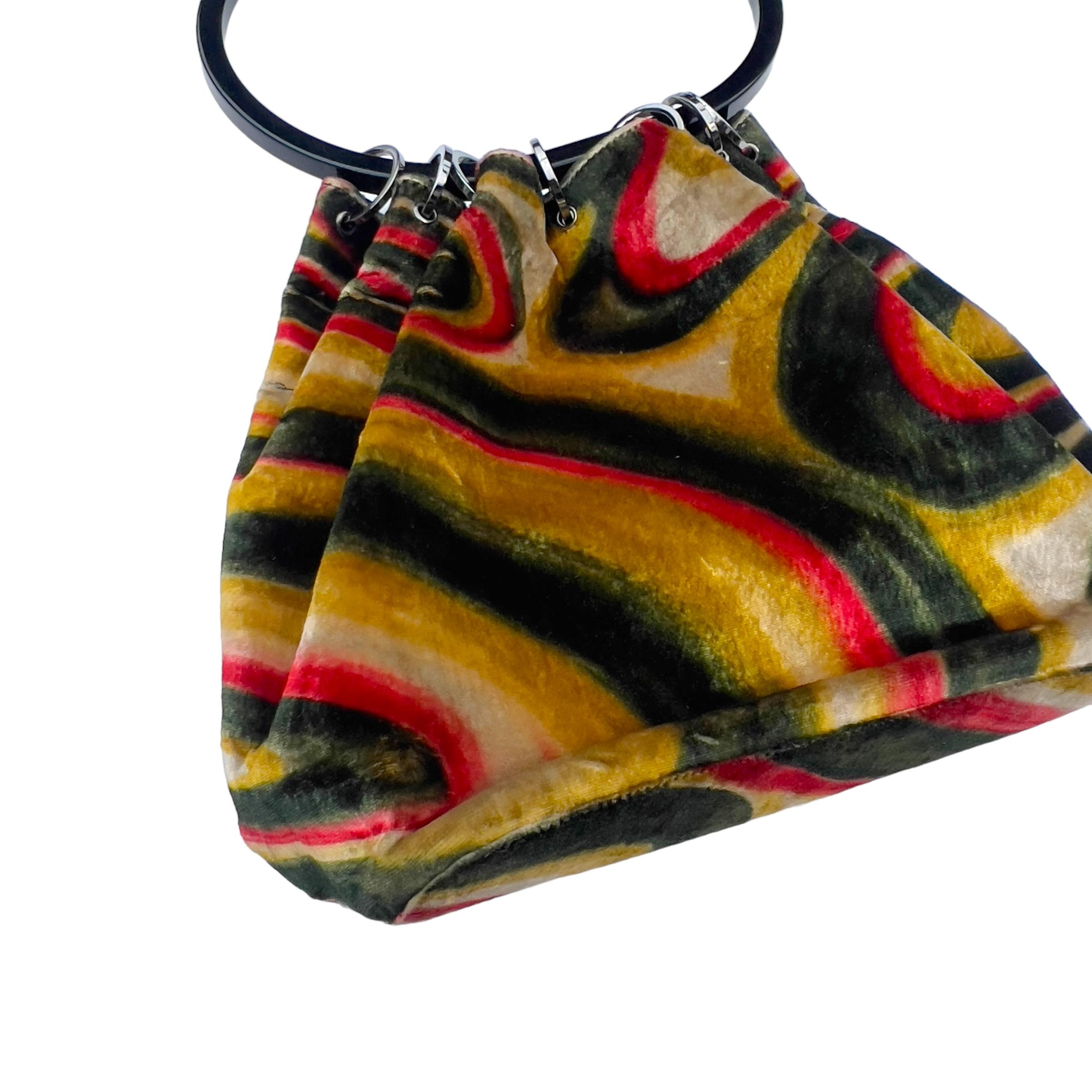 
Gucci has long been celebrated for its distinctive prints, and one of its most iconic designs is the psychedelic swirl featured on this handbag. Created by none other than Tom Ford during his influential tenure as creative director for the esteemed