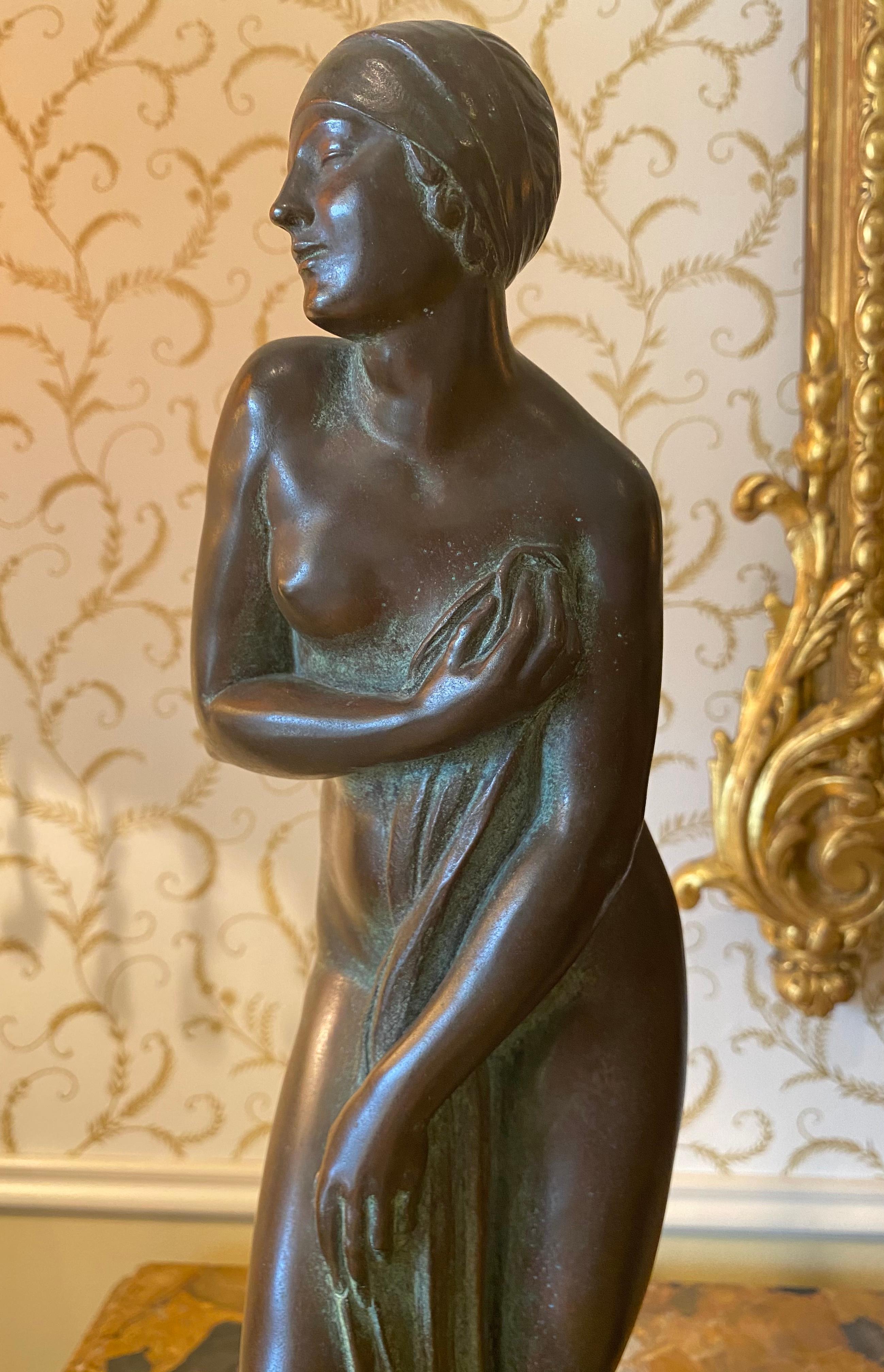 Bronze statuette representing a naked and draped woman entitled 