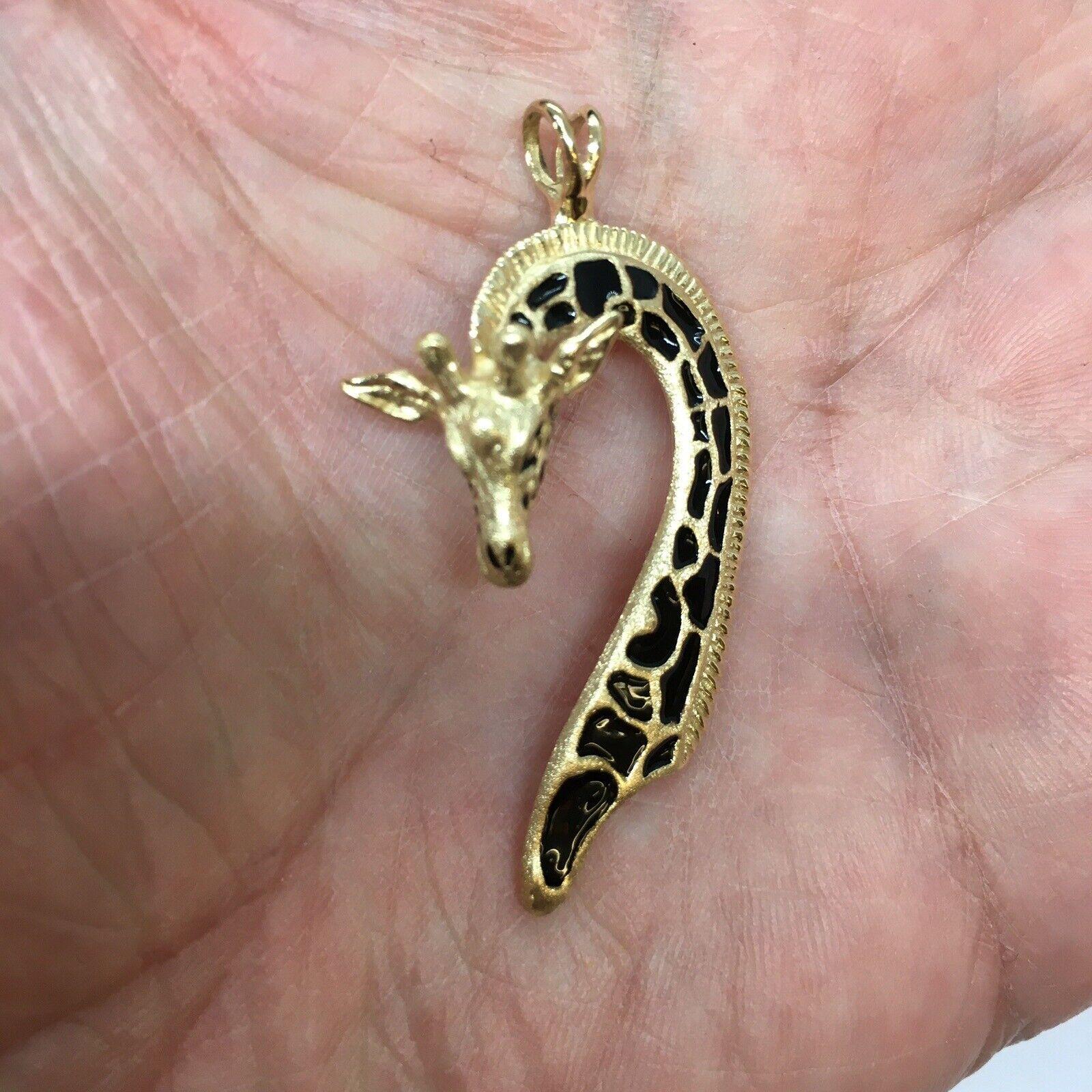 G & G Appleby 14 Karat Yellow Gold Enamel Giraffe Necklace Pendent

Gregory A. Appleby born in Van Nuys, Ca. He partnered with Gayle Bright and began sculpting precious metal jewelry. Their work has been featured in many galleries.  Gayle and
