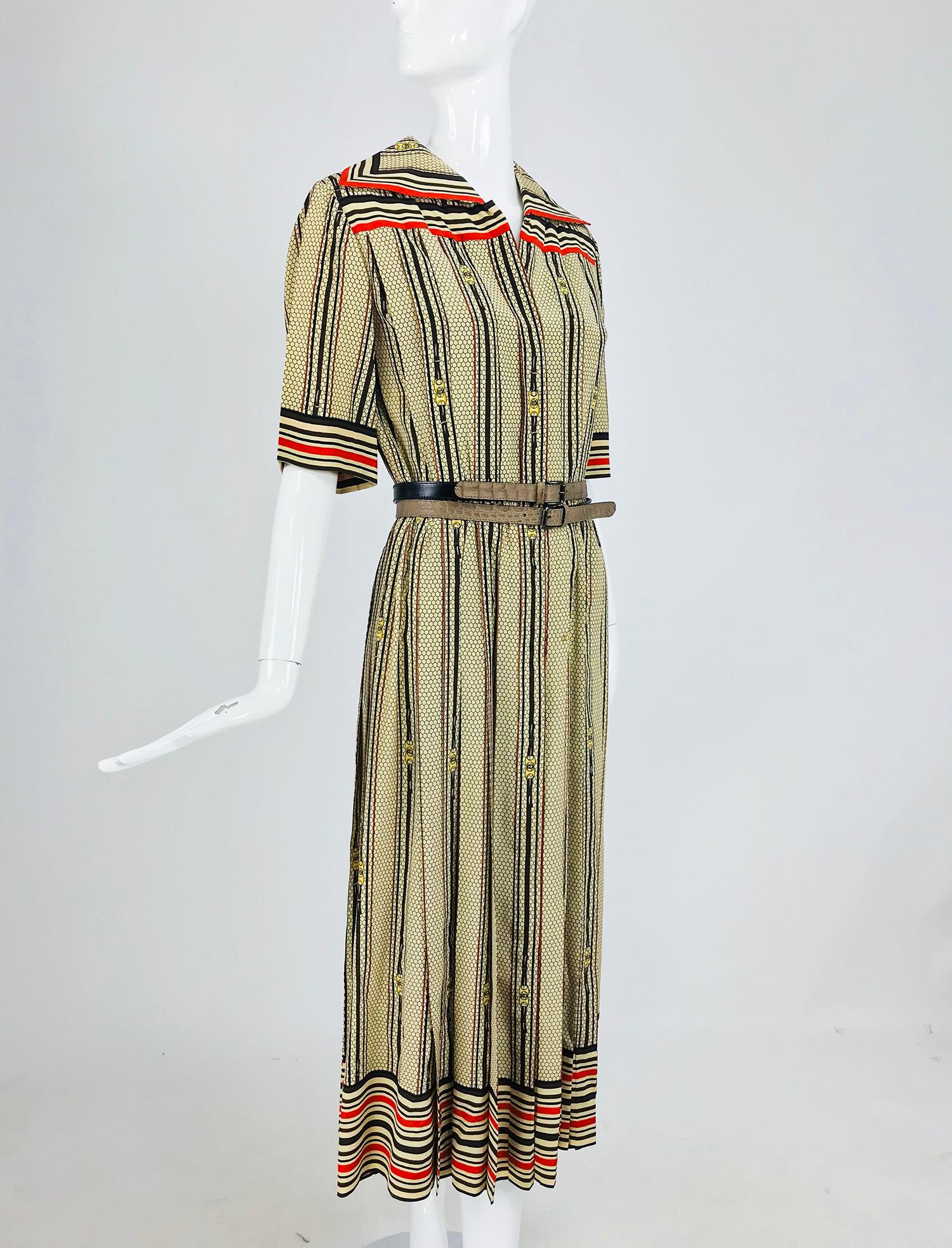 G Gucci silk shirtwaist dress in a rare logo print from the 1970s. An amazing find, this dress is done in tan, black, brown and orange silk, the overall print is a honeycomb grid design with vertical stripes  the center of each group of stripes is a