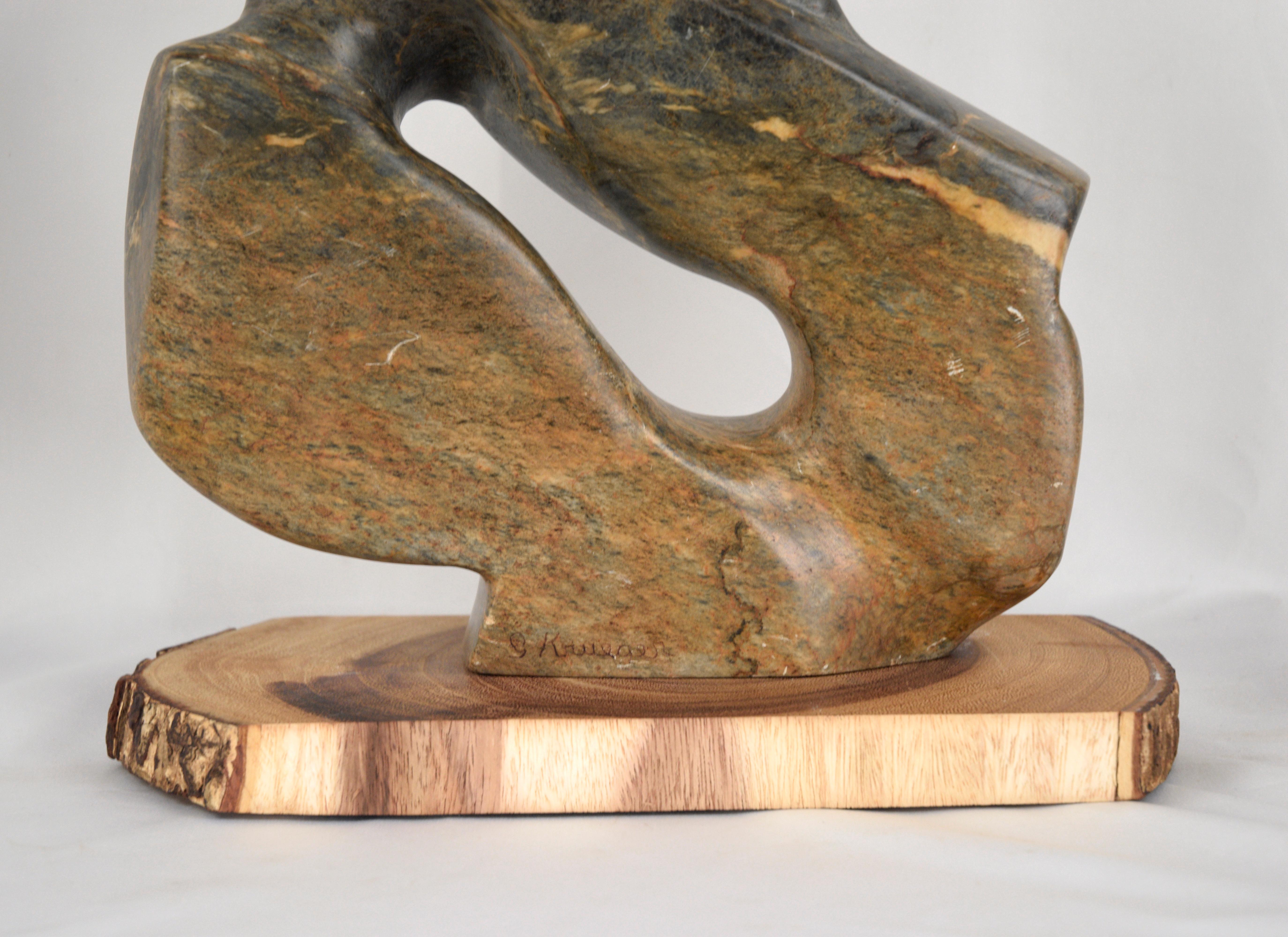 Organic abstract sculpture by G. Krueger. The Serpentine stone has gorgeous earth-toned green, yellow, and orange hues, sculpted into a flowing shape in the style of Herman Miller Sculptures. 

Wood pedestal measures 1