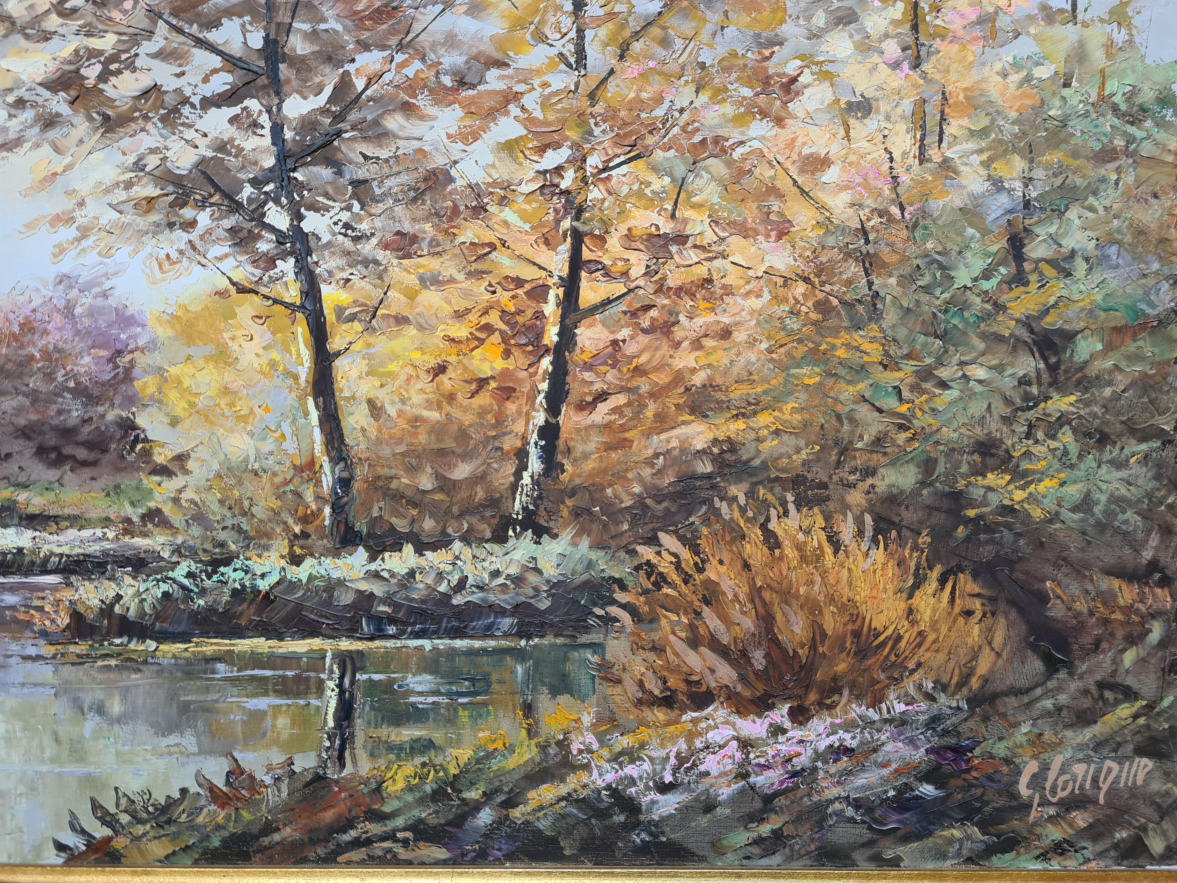 A French oil on canvas landscape of a autumn riverscape by G Lorique. The painting is signed bottom right and presented in a wood frame with gilt filet.

Lorique has captured all the charm of a lazy, early autumn day at the riverbank. He has played