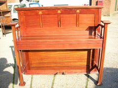 G M Ellwood, attri. An Arts & Crafts Walnut & Inlaid Piano made by J Brinsmead