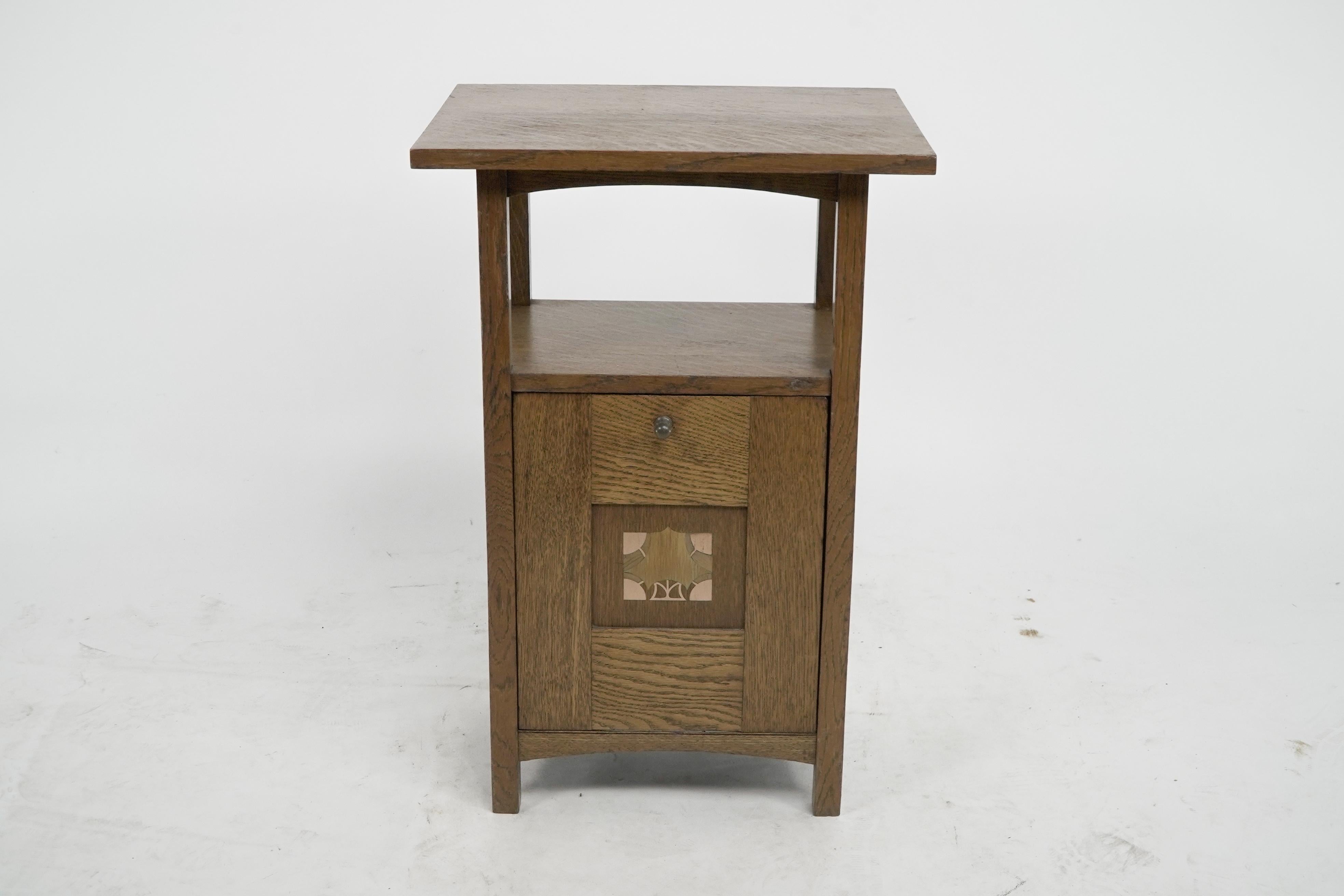 George Montague Ellwood. 
A rare Arts and Crafts oak purdonium made by J S Henry. 
A set of chairs also designed by G M Ellwood with similar inlays were exhibited at The Dublin Museum Exhibition held in 1905.