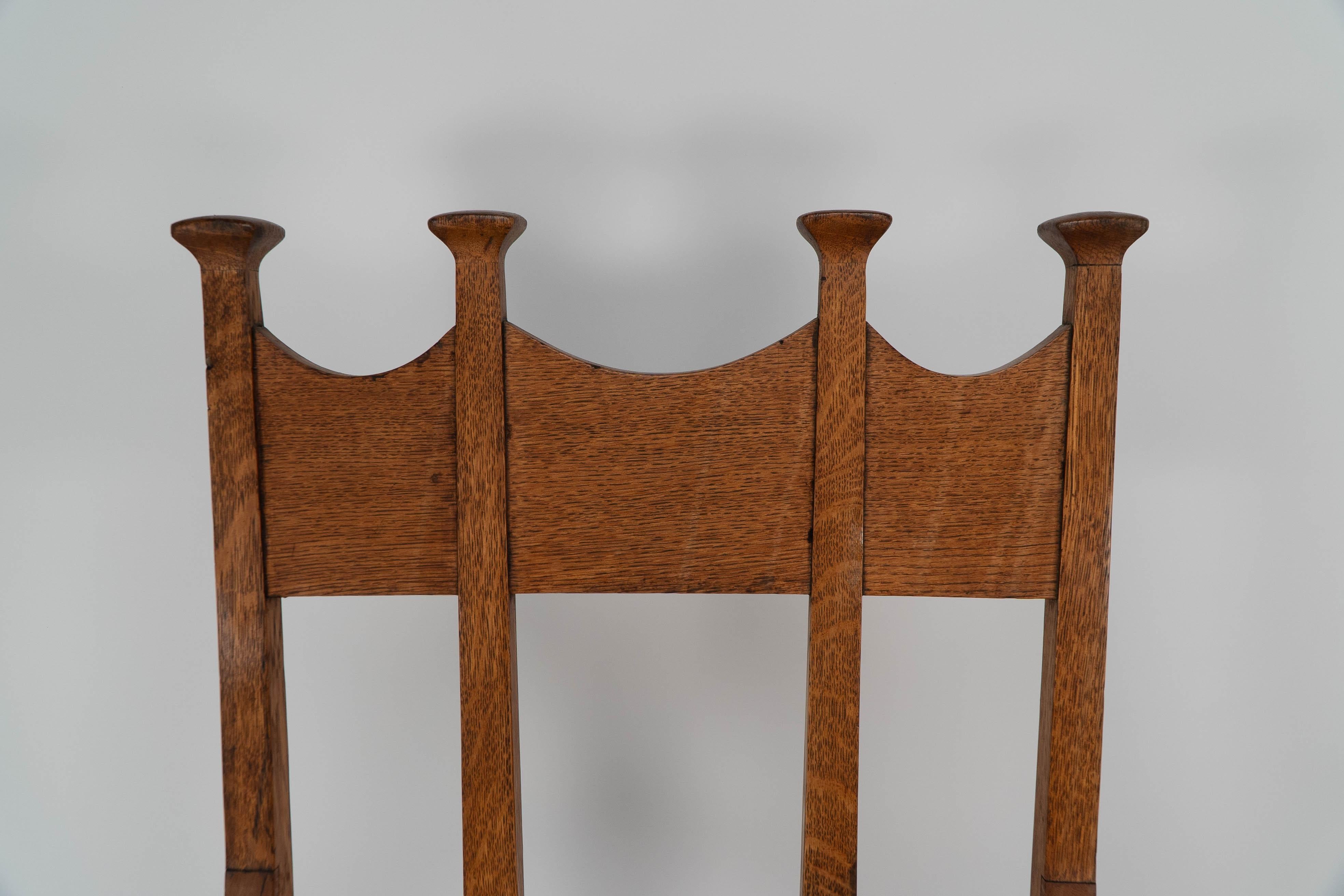 Early 20th Century G M Ellwood for J S Henry. Arts & Crafts oak throne armchair with capped finials For Sale