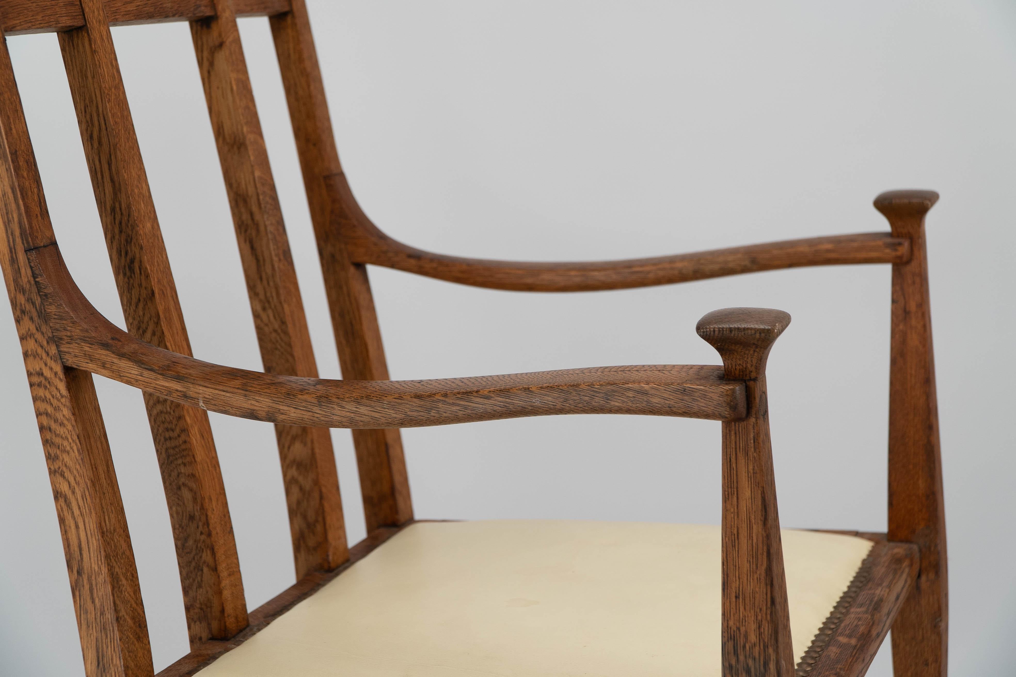 G M Ellwood for J S Henry. Arts & Crafts oak throne armchair with capped finials For Sale 1