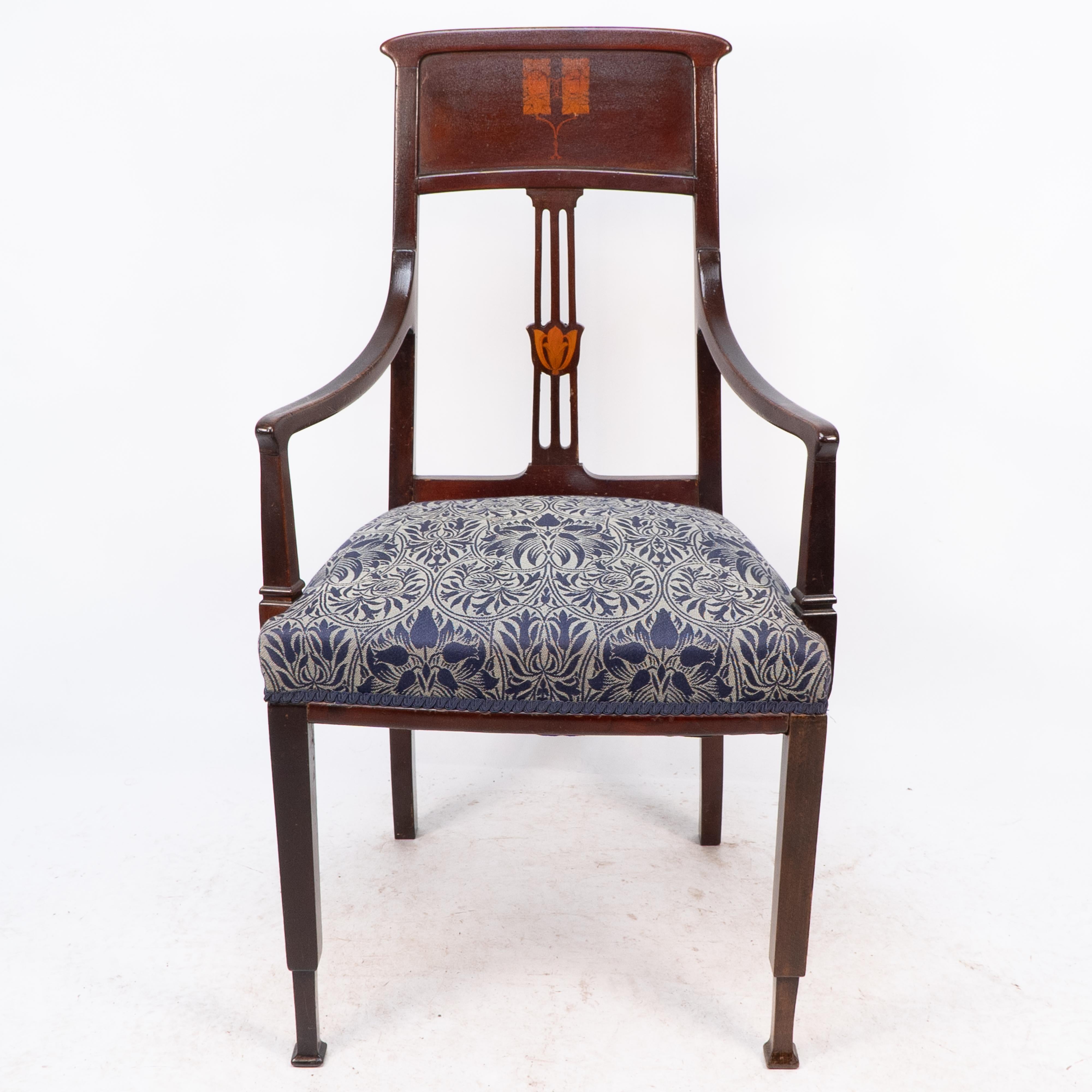 G M Ellwood for J S Henry attributed. An English Arts and Crafts mahogany armchair with stylized floral inlaid decoration with thebes style feet. Old repair to top of front leg. Professionally reupholstered.
Seat Height: 48 cm
Arm Height: 67 cm