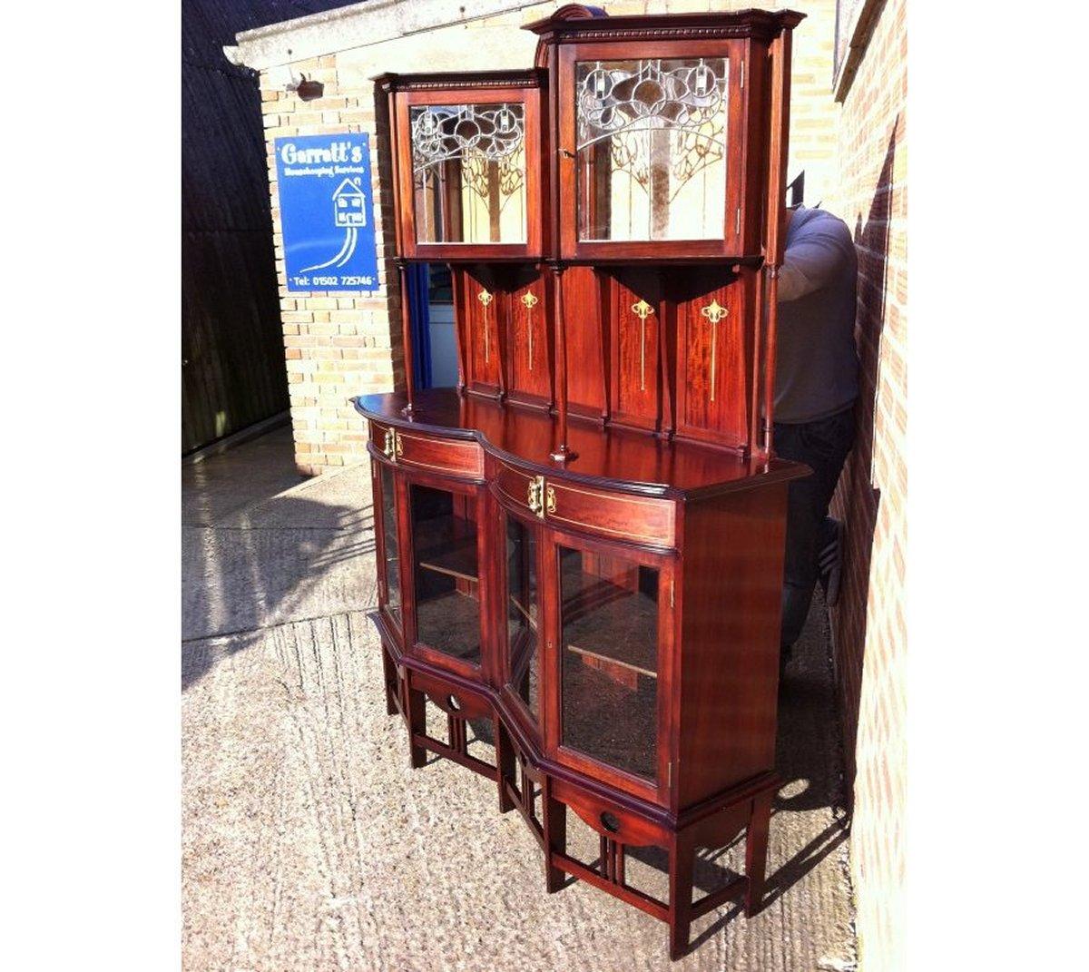 G M Ellwood for J S Henry. A fine exhibition quality 'New Art' Arts and Crafts display cabinet.
A well executed design with such fine attention to detail, twin triangular display cabinets to the upper and lower sections the upper with lead and glass