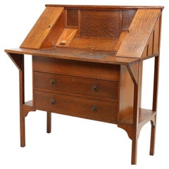 G M Ellwood for J S Henry. An Arts & Crafts oak writing desk