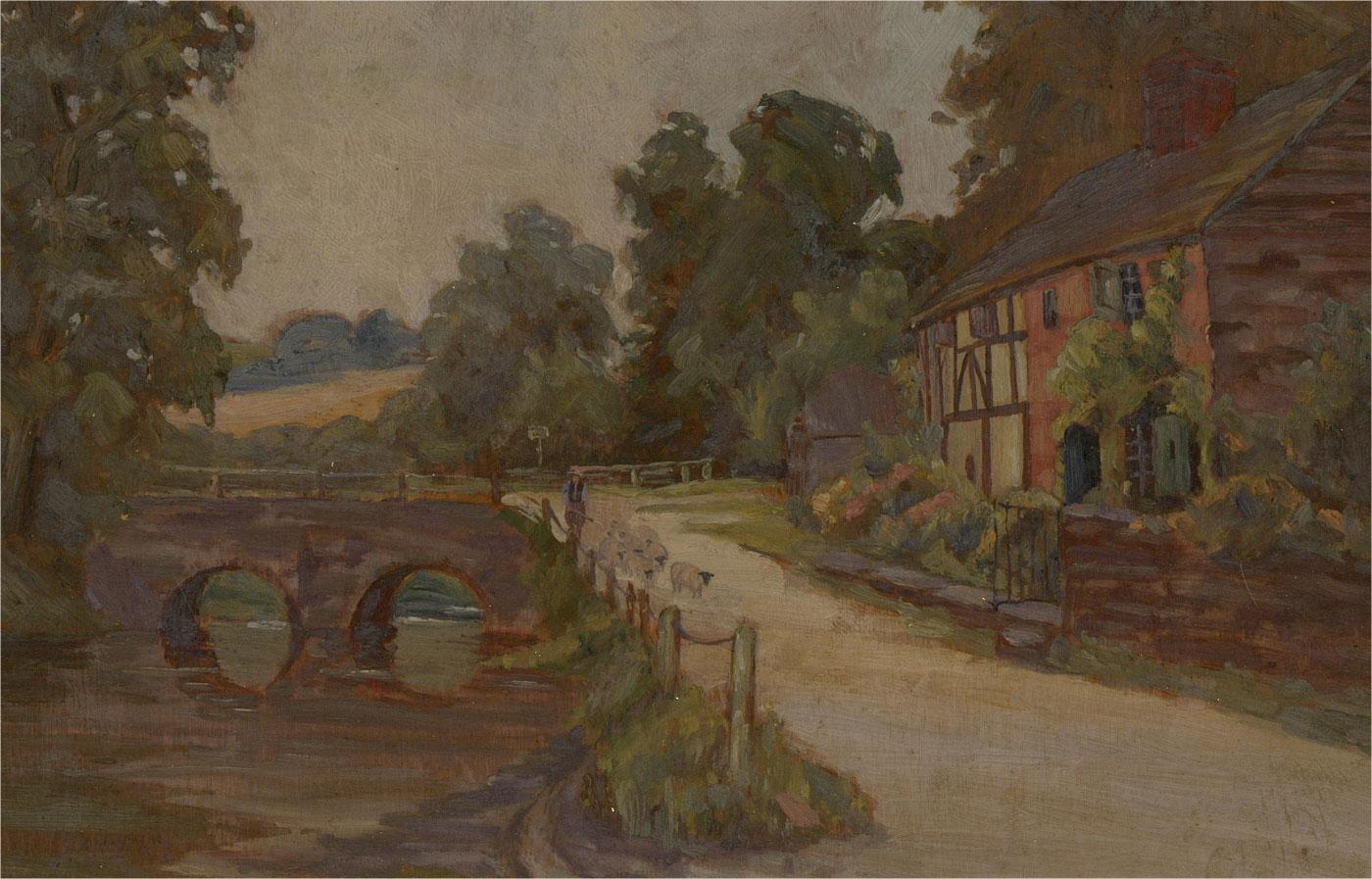 A charming early 20th Century village scene with a shepherd guiding his flock along by a river with cottages and pretty gardens on the right. The artist ha signed to the lower left corner and the painting has been presented i a 20th Century gilt