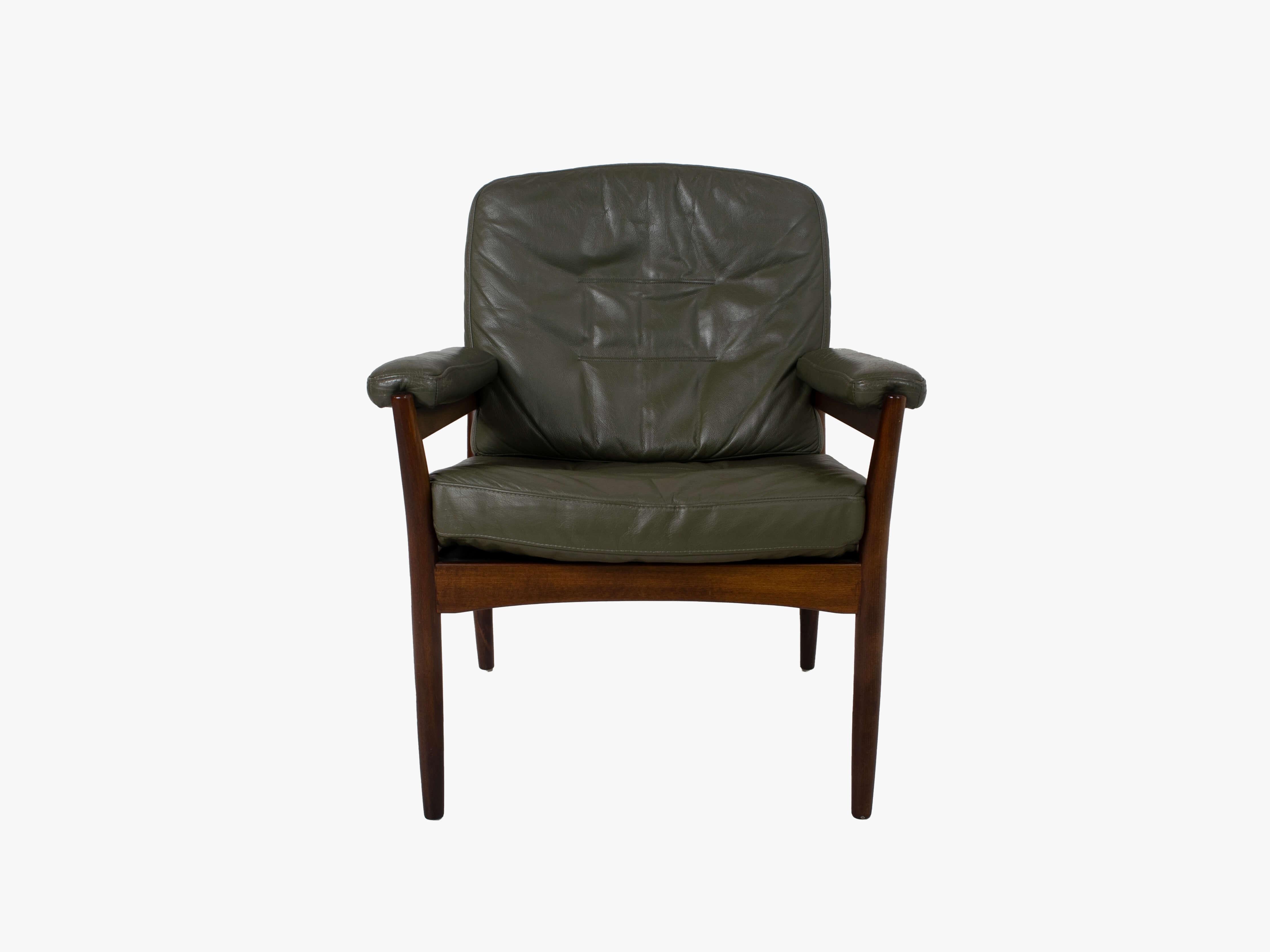 G-Mobel arm chair for Göte Möbler, Sweden in about 1970. A solid wooden frame with a dark green upholstery gives it a robust look. The chair is in good condition with most of the leather wear on the armrests (see photo). Clearly marked with a