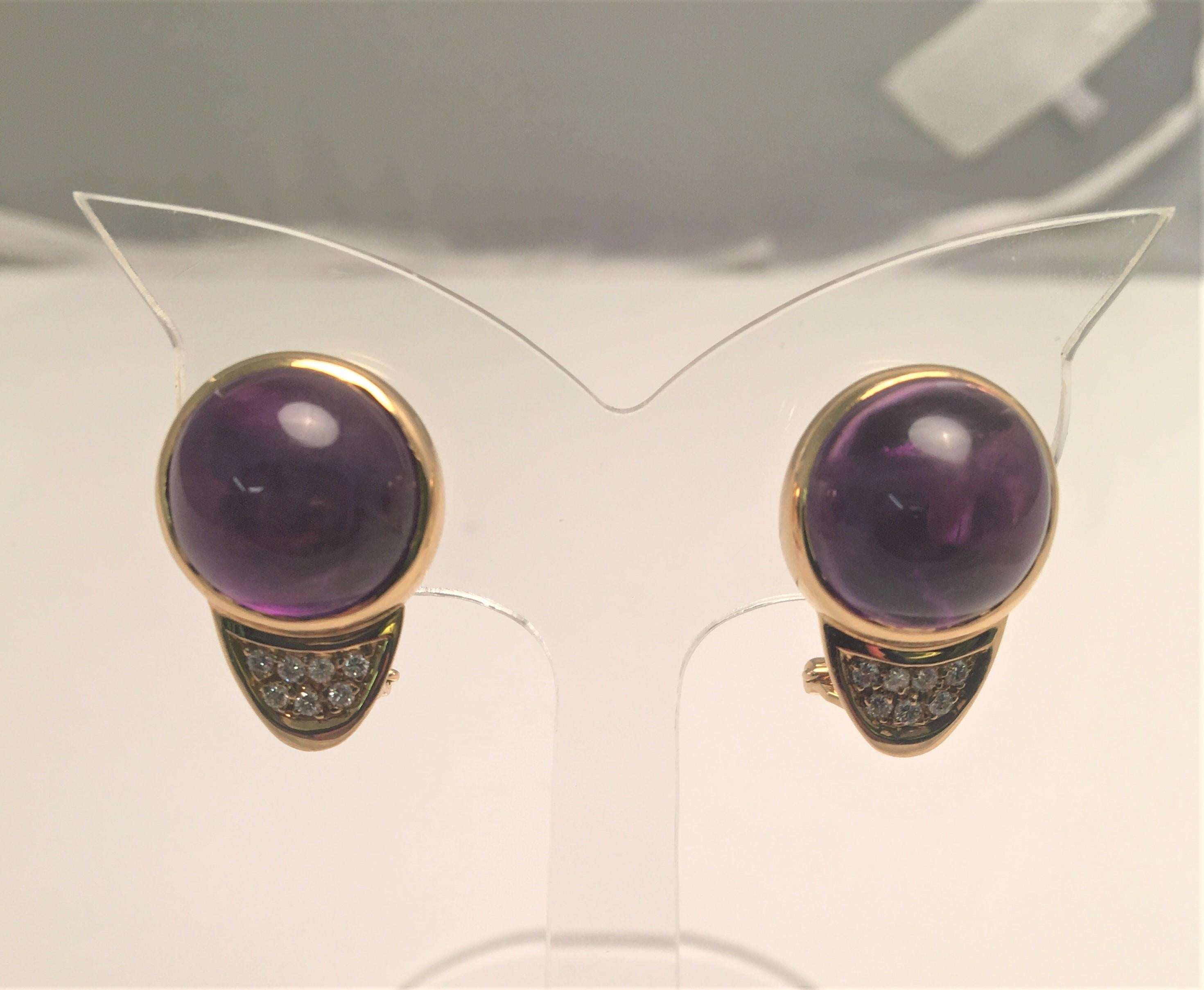 By designer G. Petochi
2 cabochon amethyst stones approximately 13mm round
14 round brilliant cut diamonds (7 per earring), bead set
Diamonds are approximately .14 total weight, F-G color, and VS2-SI1 clarity
Omega closure with collapsible post 
18K