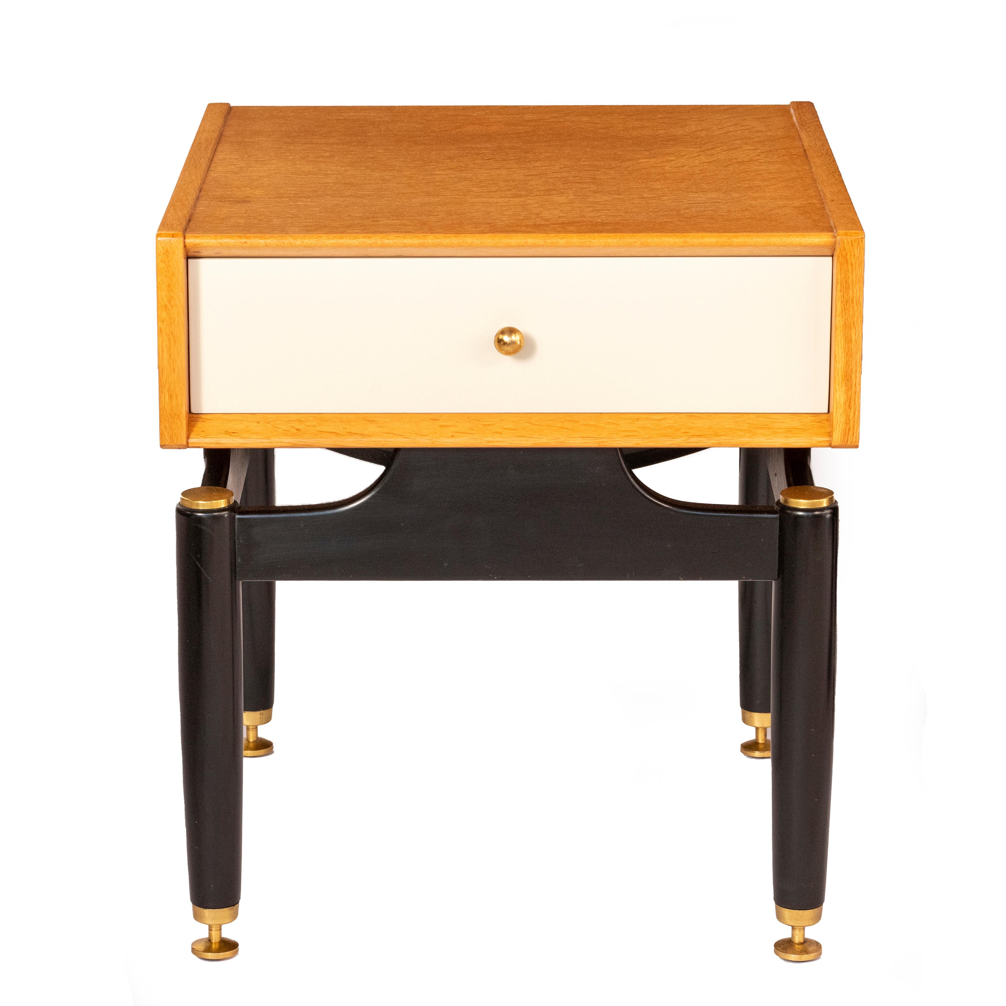 G-Plan Bedside Table, England circa 1955
Oak and enamel finish
Brass handles and mounts
Black enamel base
Makers stamp to inside of drawer
53 cm high x 48 cm wide x 48 cm deep