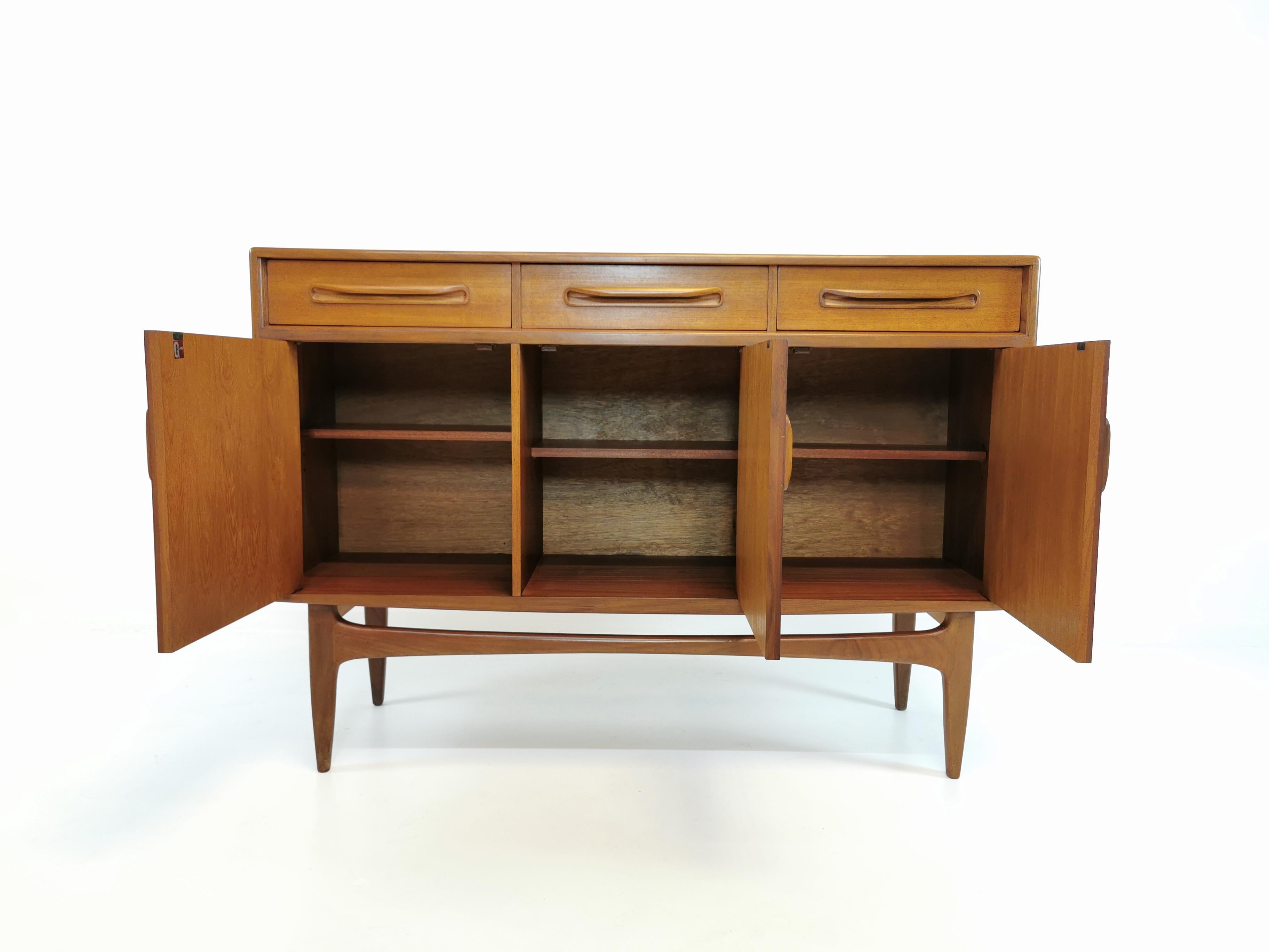 Compact but tall, G-Plan Sideboard designed by V B Wilkins for E. Gomme / G-Plan, England 1960s. 

Featuring drawers, spacious cabinets and internal shelving.