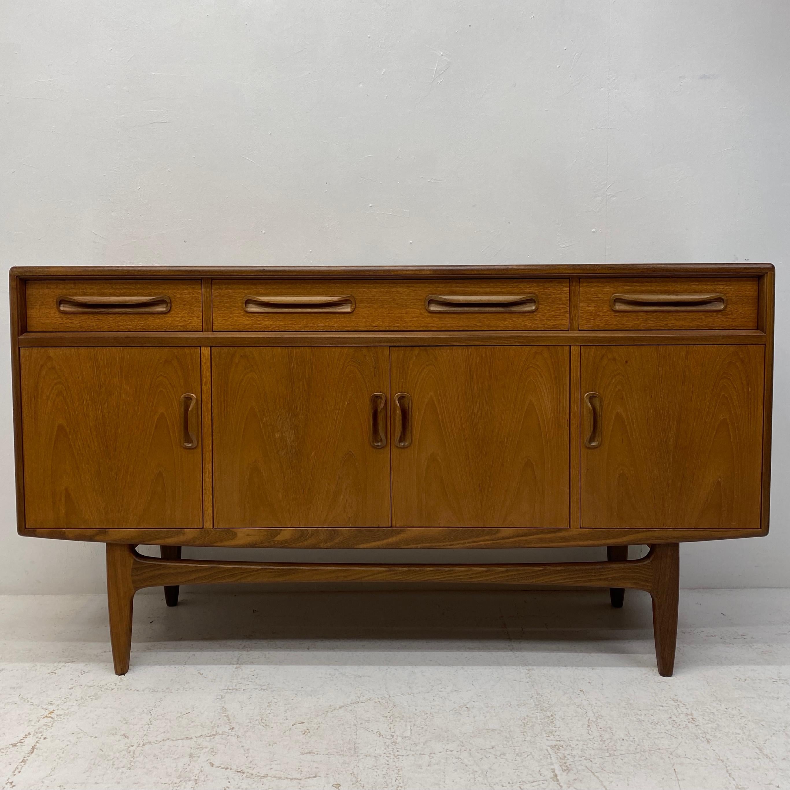 A fabulous G Plan Fresco vintage sideboard with one large cupboard with an adjustable shelf, two smaller cupboards with adjustable shelves & three drawers, including a lined cutlery drawer. 1960s. The sideboard is constructed from solid teak &