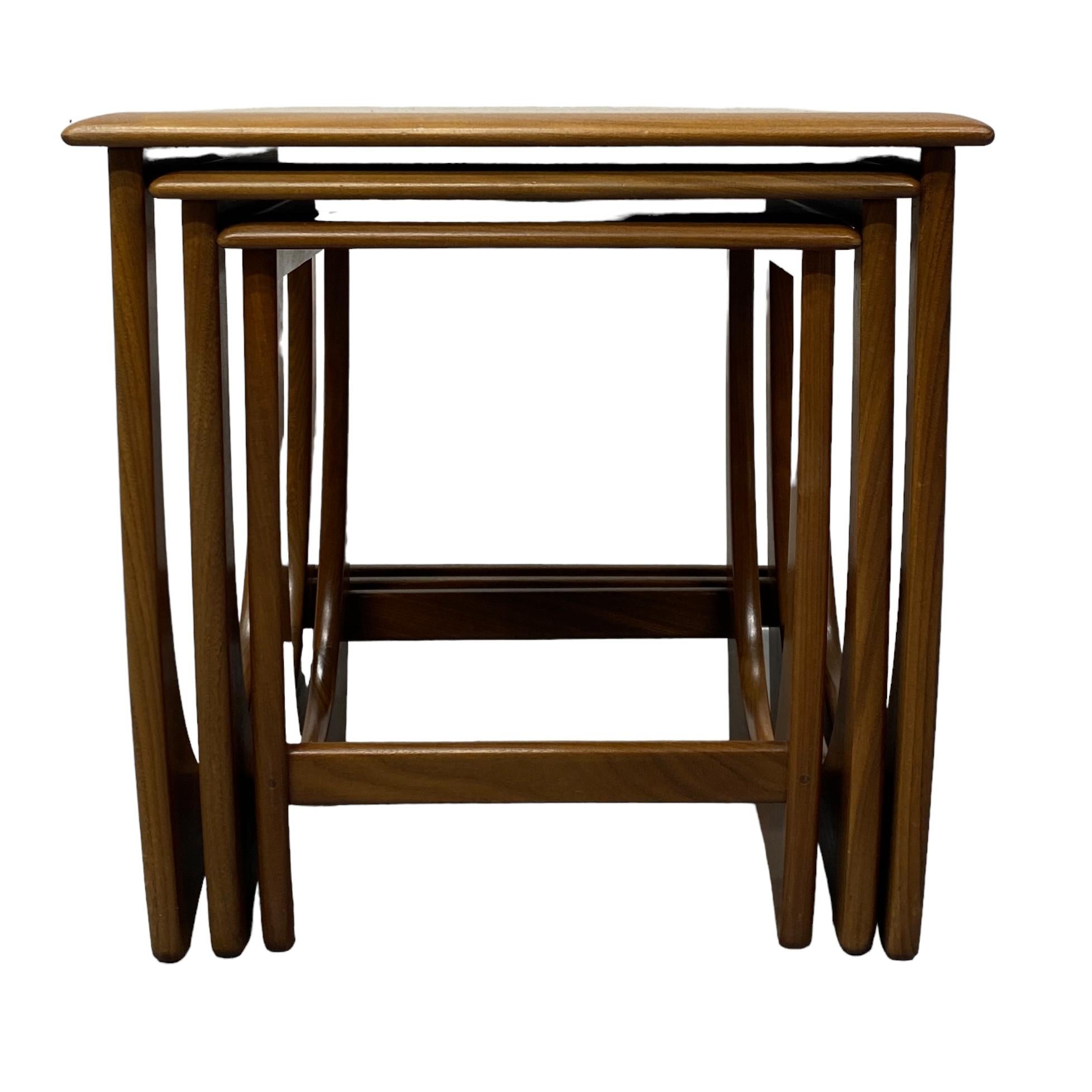 This set of three 1960s pull out nesting tables designed by Victor Wilkins for British brand G Plan are from the renowned fresco range. The three teak & afromosia nesting tables have a stunning iconic shape & are in good vintage condition with a
