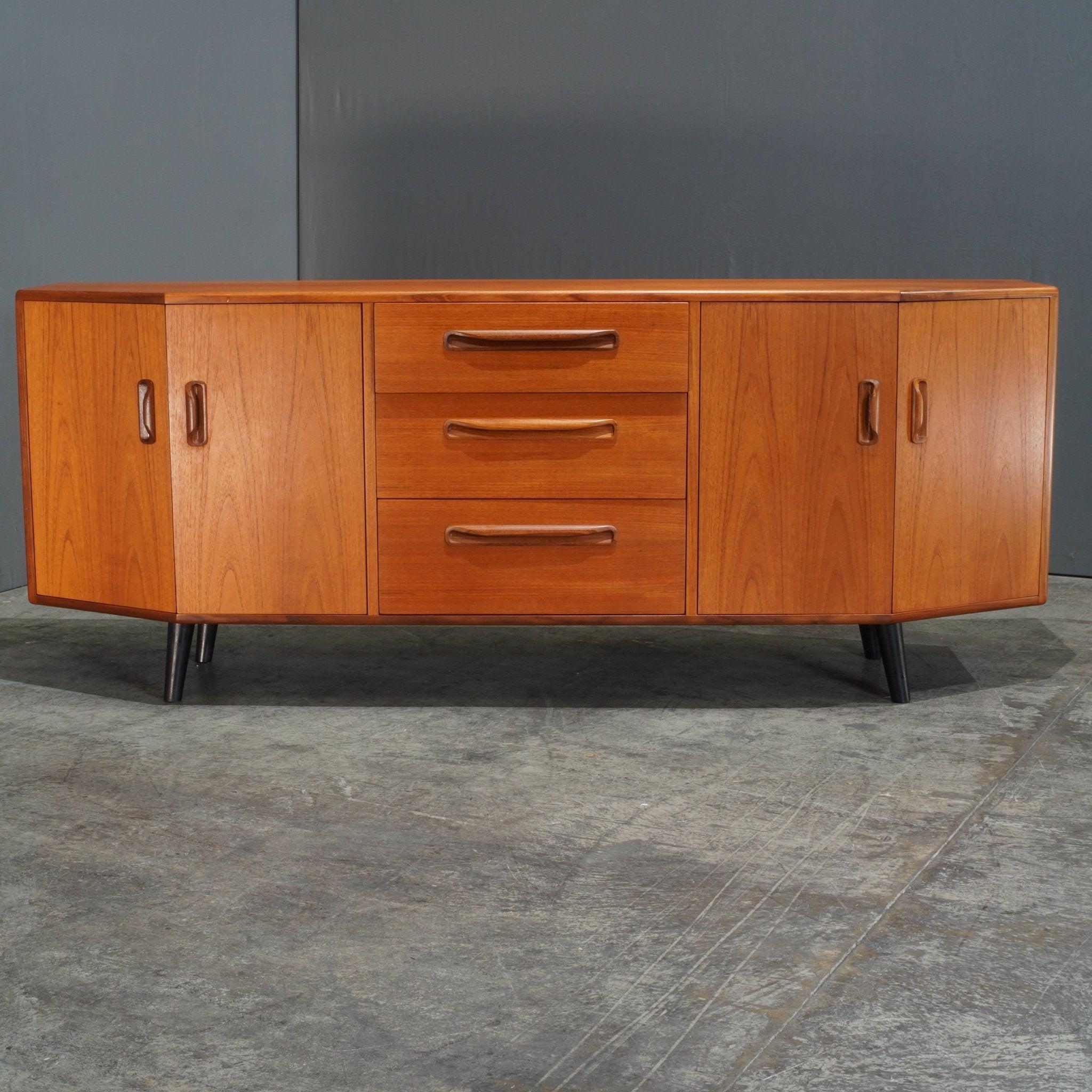 The G Plan Fresco Teak Sideboard is a stunning example of mid-century design, crafted with elegance and functionality in mind. Its warm, richly grained teak exterior showcases G Plan's dedication to high-quality materials and timeless style. The