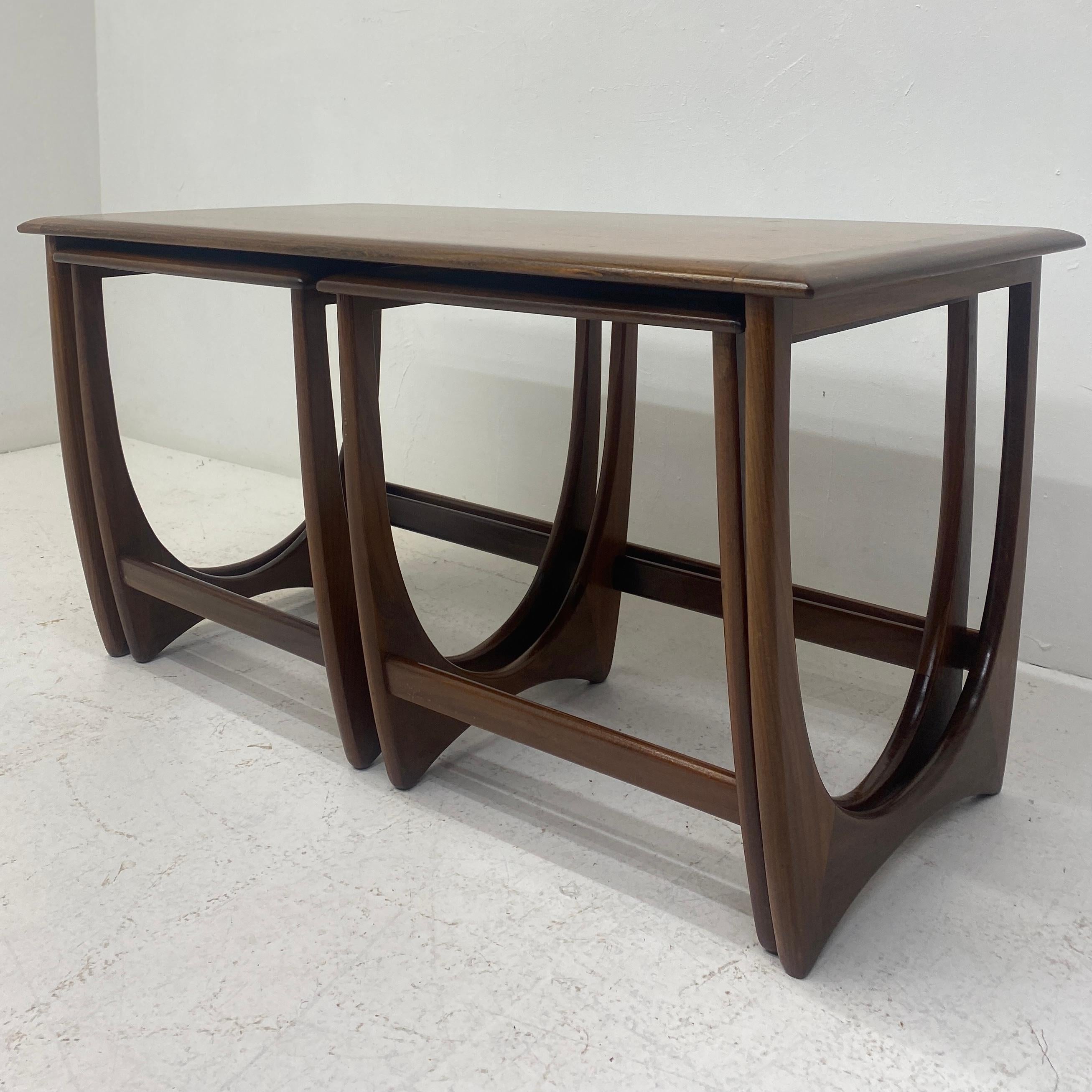 A beautiful set of midcentury nesting tables by British furniture maker G plan designed by Victor Wilkins as part of the astro range. Gorgeous grained tops and solid wood legs make these tables stand out from the crowd. One rectangular & two square