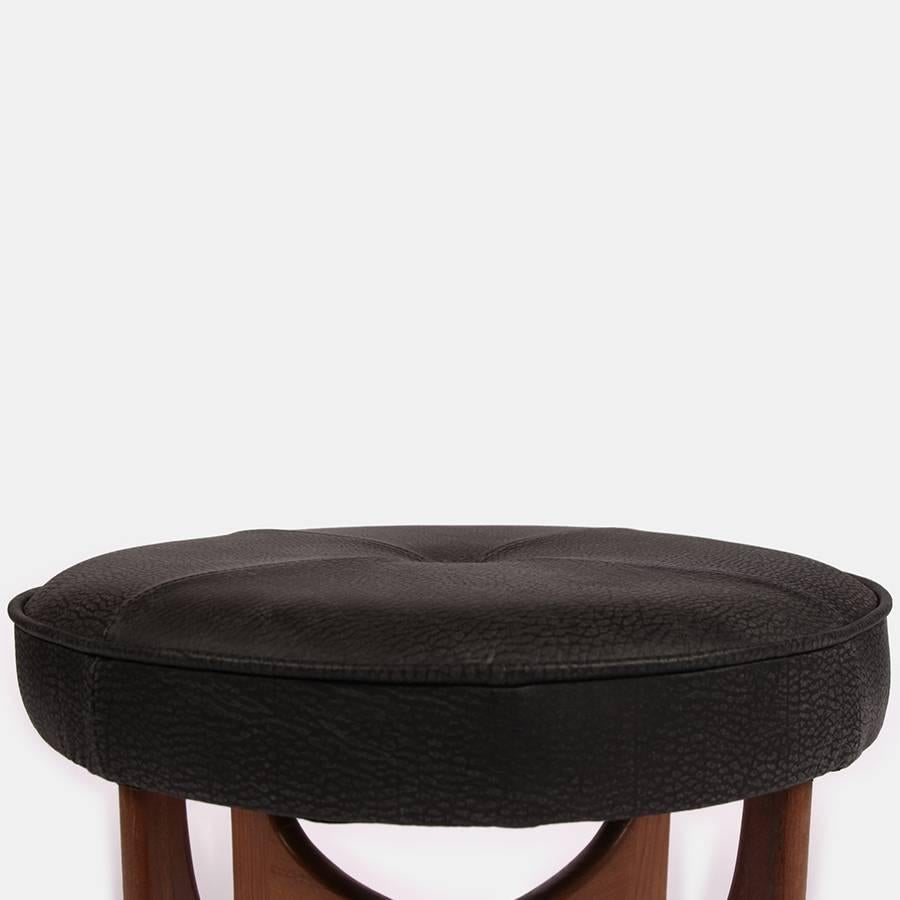 A lovely G-Plan Ernest Gomme foot stool with teak frame and a buttery black leather Andrew Martin upholstered seat.