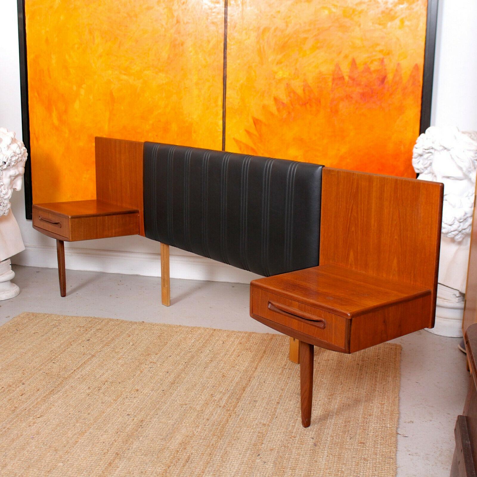 An impressive G Plan teak and black leatherette cushioned continental headboard.