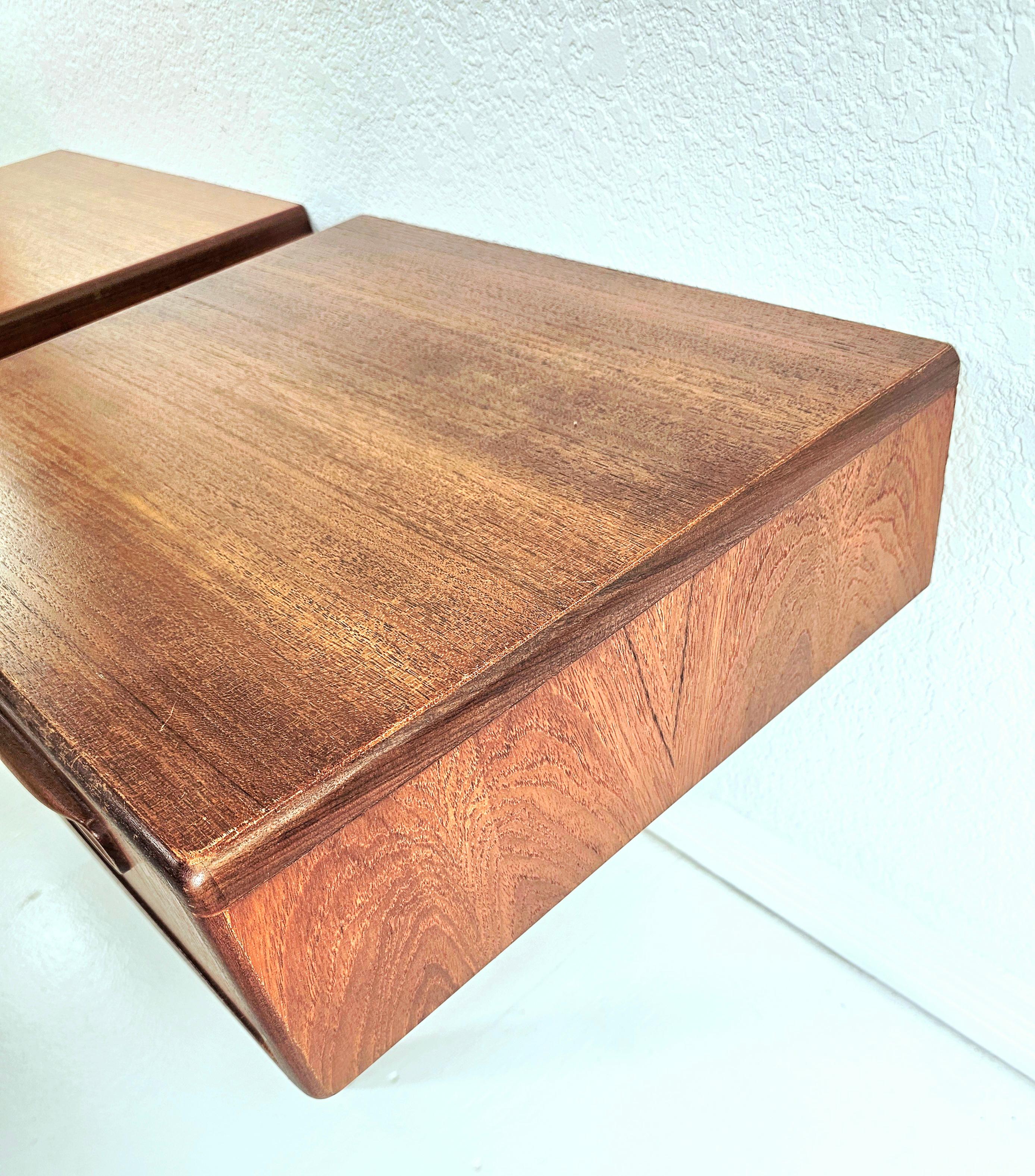 Very stylish pair of teak vintage floating bedside tables. These were made by G- Plan and their date of birth is March 1967. The condition is excellent for their age, they are clean, sturdy and sound. One table top has a couple of extremely minor