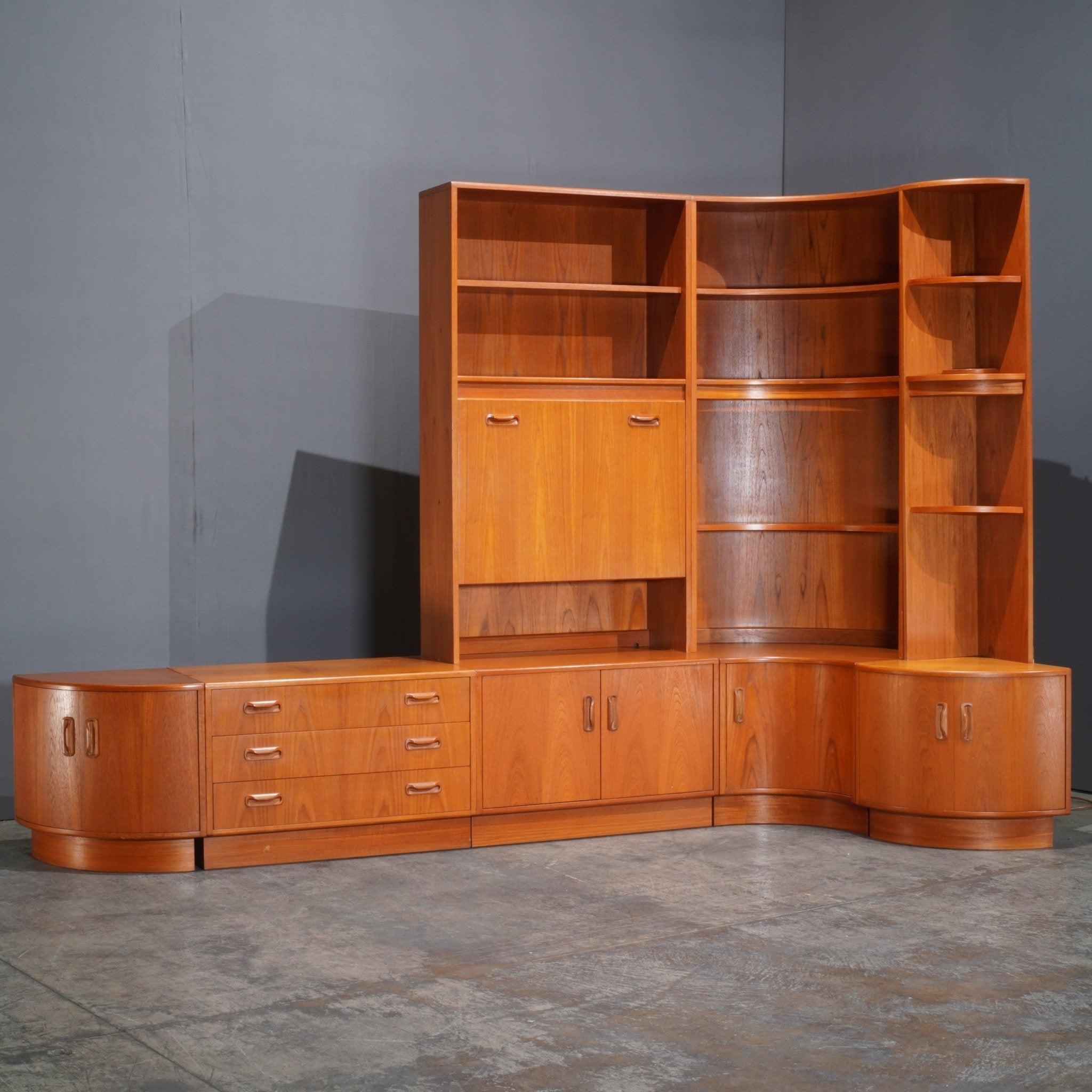 The G Plan Teak Modular Wall Unit is a quintessential example of mid-century modern design, blending functionality with timeless elegance. Crafted from rich teak wood, this wall unit offers a versatile storage solution with its modular components,