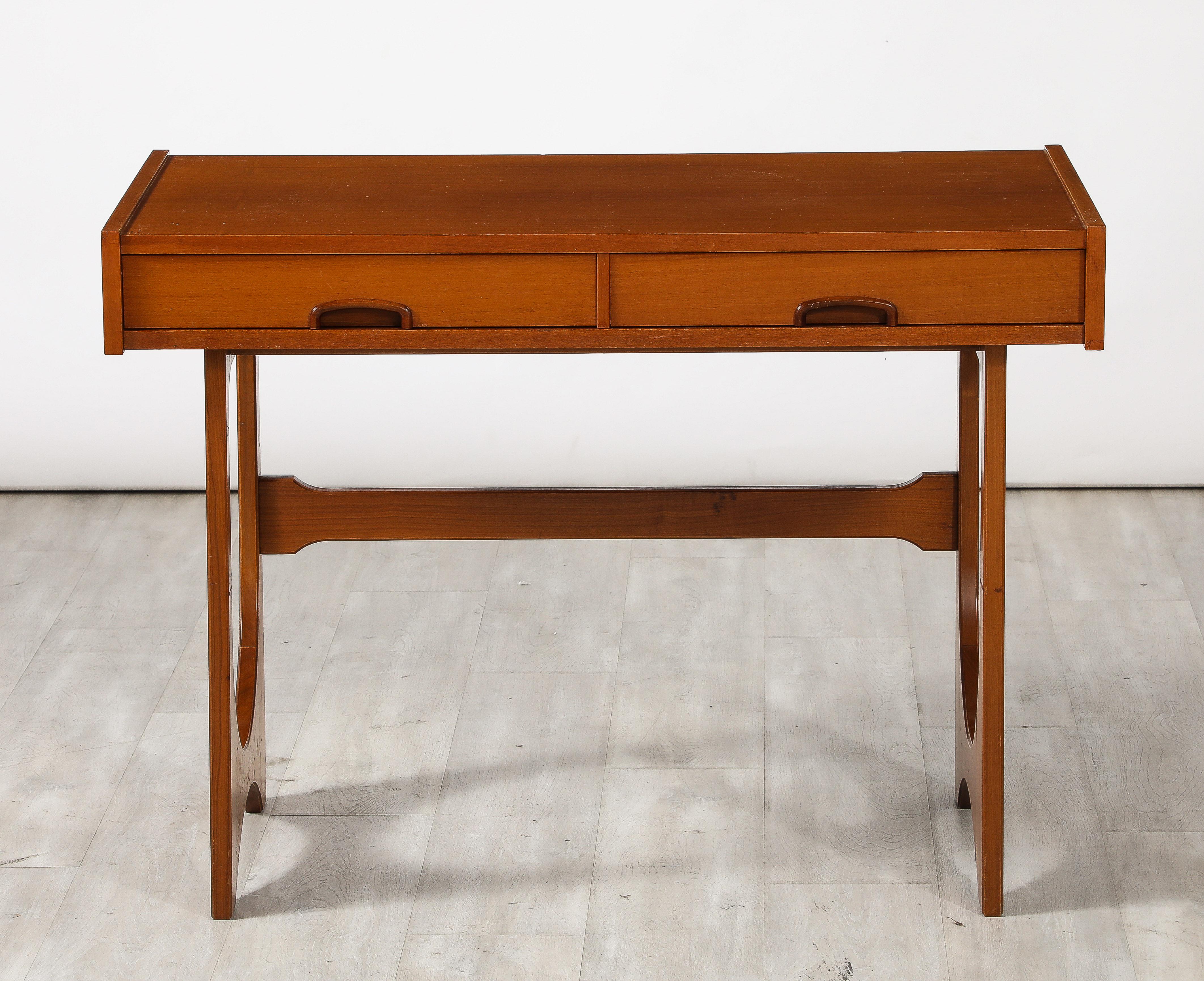 A mid-century modern teak writing table with two ample drawers an an ample writing surface; with wonderful lines.  
Designed by R. Bennet for G. Plan, England, circa 1970 
Size: 29 1/2' high x 41 1/4
