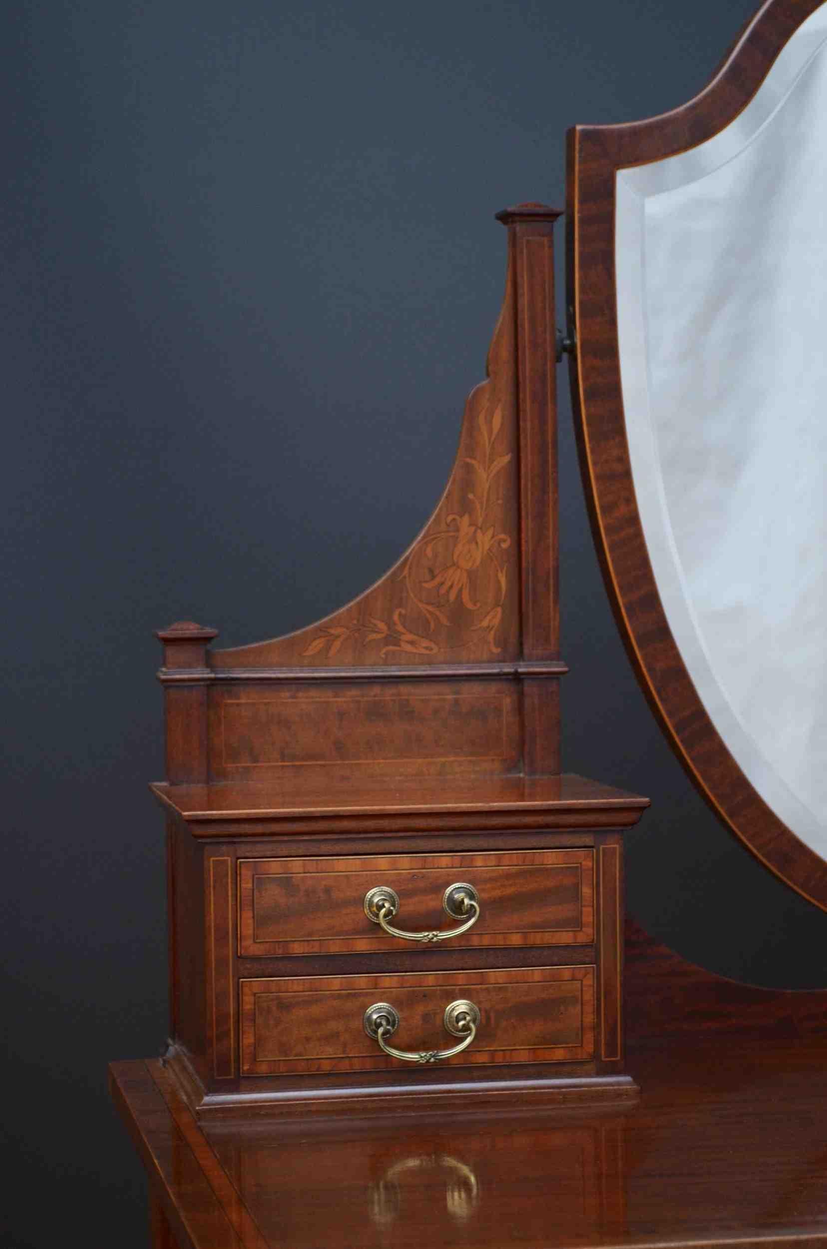 J09 Fine quality Edwardian mahogany and inlaid dressing table, having shield shaped mirror with original slightly foxed glass supported on inlaid uprights terminating in small inlaid drawers above satinwood crossbanded figured mahogany top and three