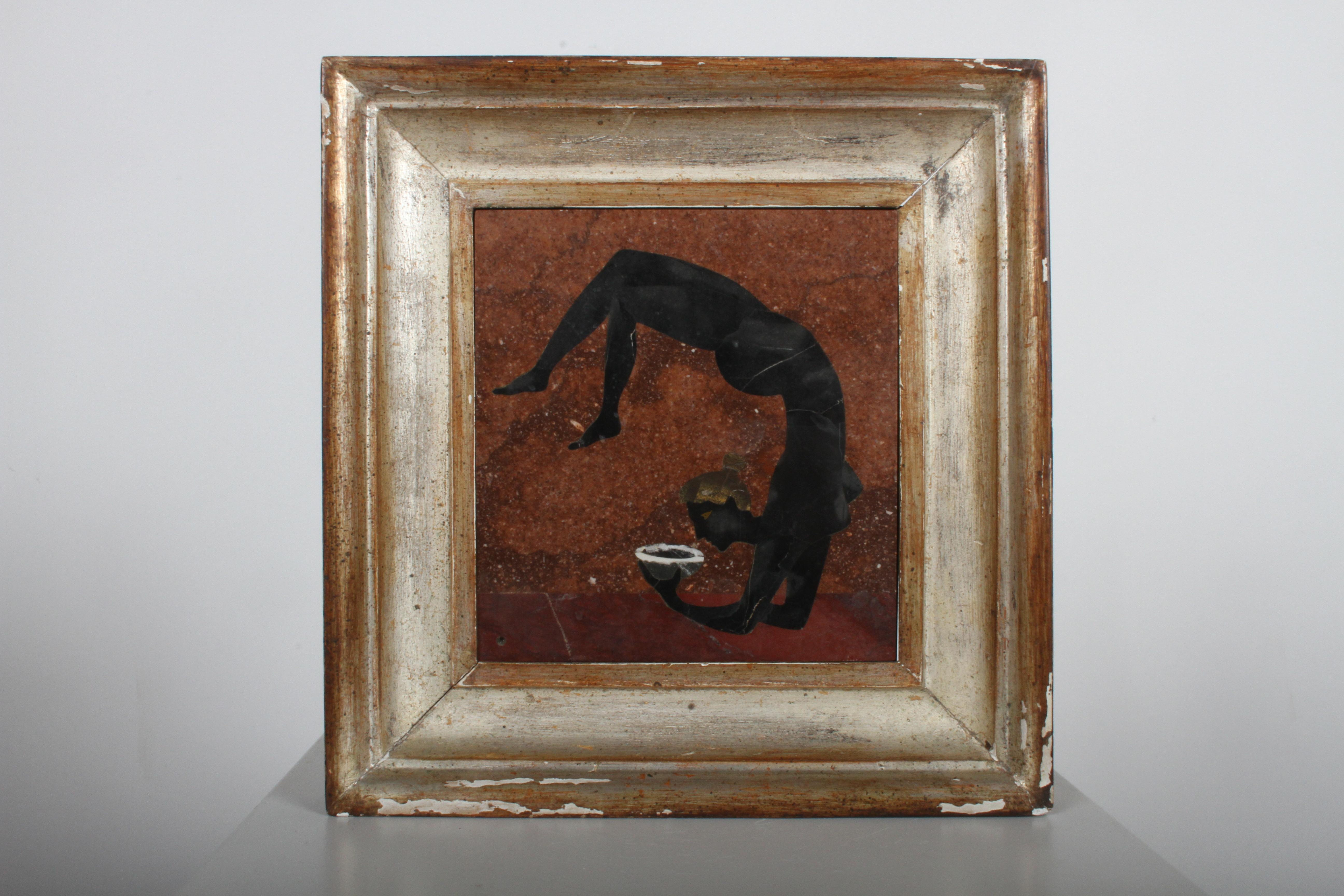 Giovanni Ugolini - Italy circa 1956, framed Pietra Dura polished stone mosaic plaque. Depicts a nude female acrobat, holding a bowl. Verso: retains original label, marked made in Italy 1956, plus artist name Calde. Light scuffs to plaque, wear to