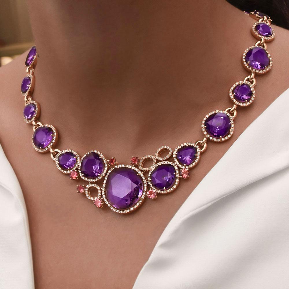 Crafted by g.Verdi of Italy this beautiful necklace is designed in 18 karat rose gold with 18 pear and oval cut Amethyst stones. Each Amethyst stone is surrounded by a diamond bezel. There are 7 round Pink Tourmaline highlighting the front section