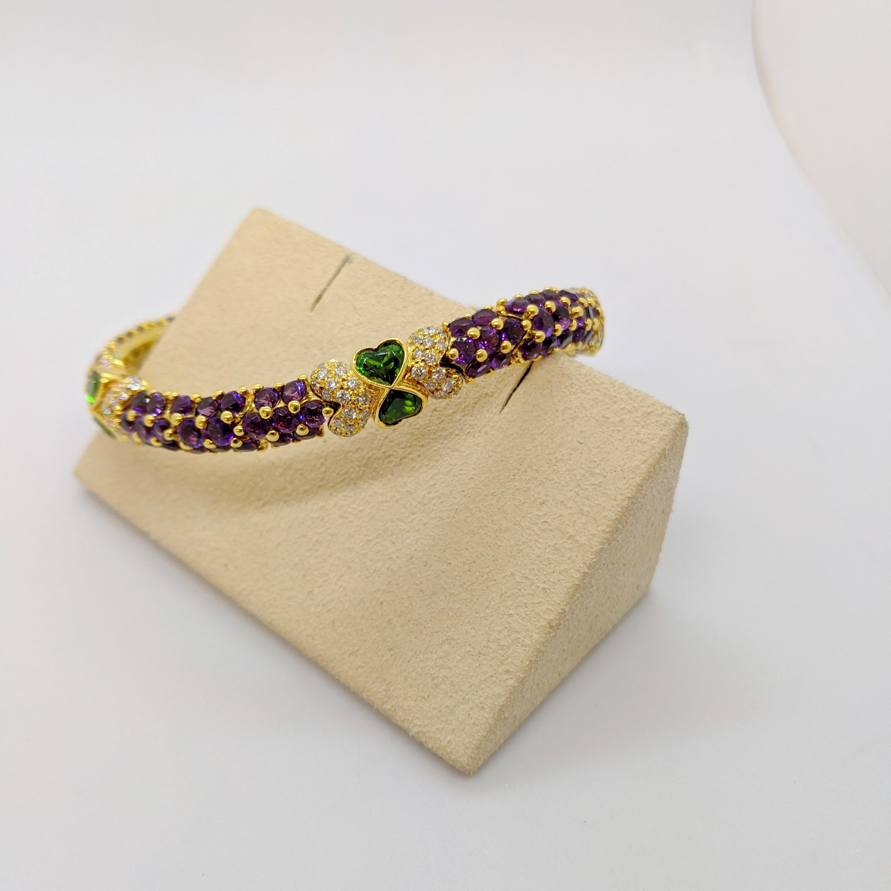This bracelet was designed by G. Verdi of Italy. The round brilliant cut Amethyst stones are set in 18 karat yellow gold prongs that give a beautiful beaded effect. Round brilliant Diamonds and heart shaped Tsavorites join the Amethyst links. When