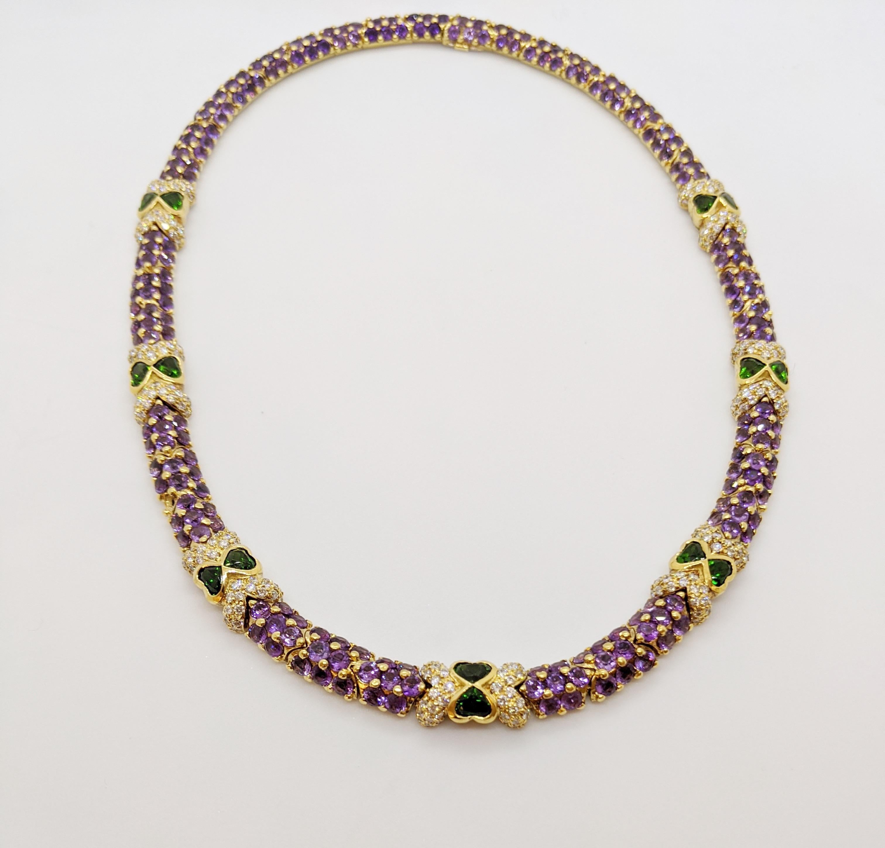 This necklace was designed by G. Verdi of Italy. The round brilliant cut Amethyst stones are set in 18 karat  yellow gold  links with prongs that give a beautiful beaded effect. Round brilliant Diamonds along with 14 heart shaped Tsavorites join the