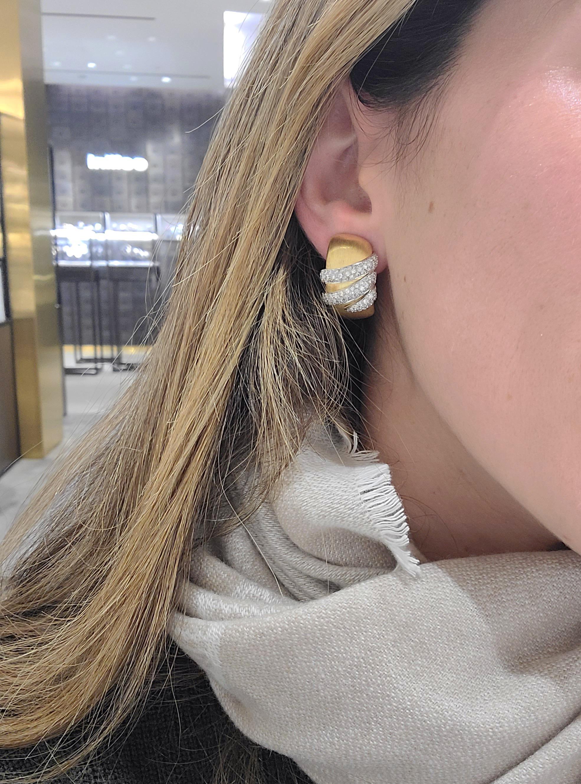 Designed by G. Verdi of Italy exclusively for Cellini Jewelers NYC, these elegant earrings are set in 18 Karat Brushed yellow gold, and accented with 1.54Ct. Of round brilliant diamonds set in 18KT. White Gold, which appear to gracefully wrap around