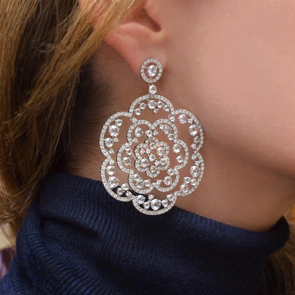 Made in Italy for Cellini by the famed jewelers g. Verdi ,these exquisite  18 kt gold hanging diamond earrings give you the feeling of a lace pattern. The large open worked flowers are set with rose cut and brilliant cut diamonds. The combination of