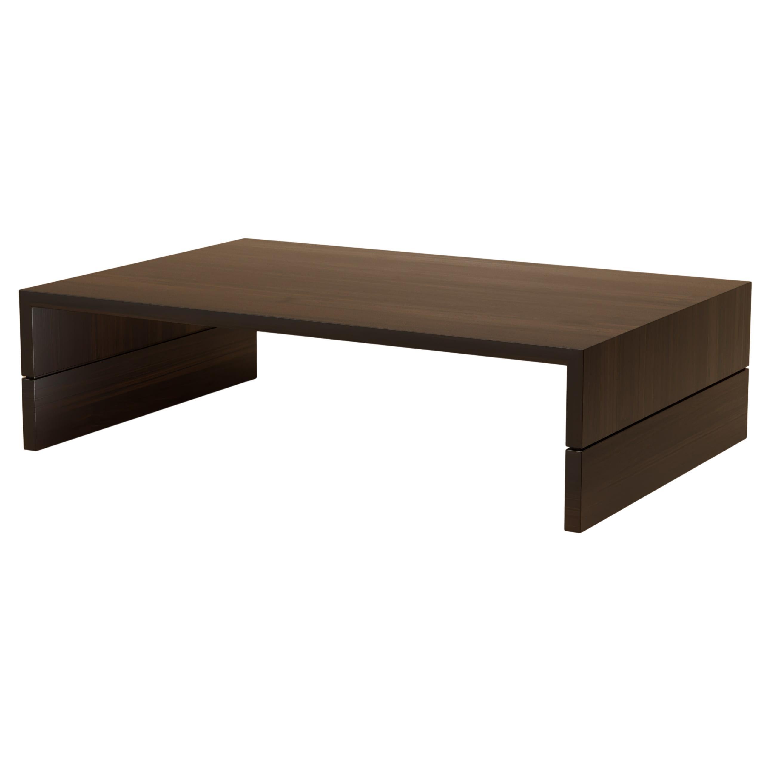 The Grant Side Table distills elegance into geometry. Walnut planes frame concealed drawers lined in leather, creating a piece that balances precision with quiet luxury. Its form is compact but never ordinary, each proportion designed to feel both