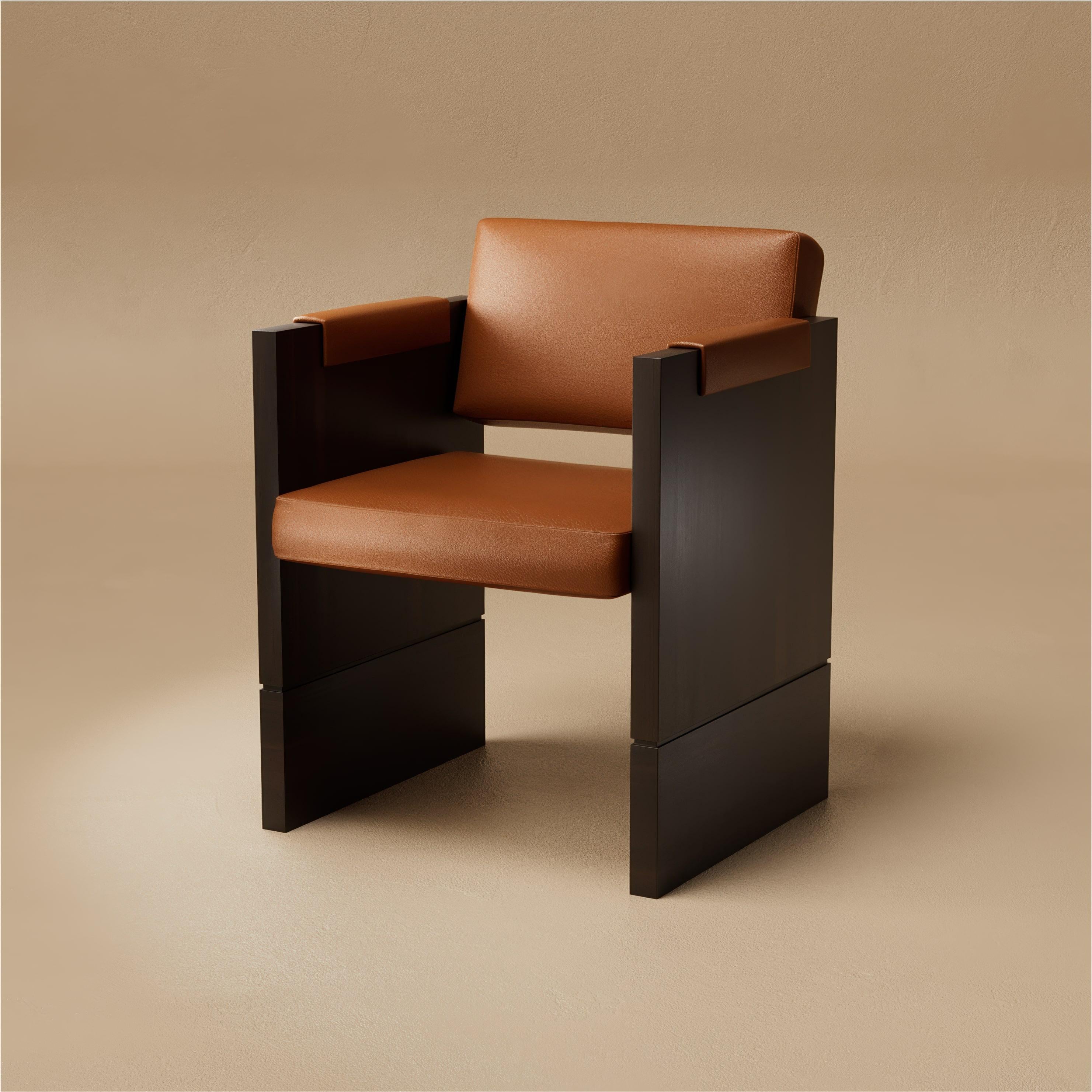 The Grant Dining Chair is carved for both comfort and presence. A walnut frame, sculptural in form, holds a tailored seat and upholstered arm pads, bringing warmth and sophistication to the dining table. Its profile is elegant yet grounded, designed