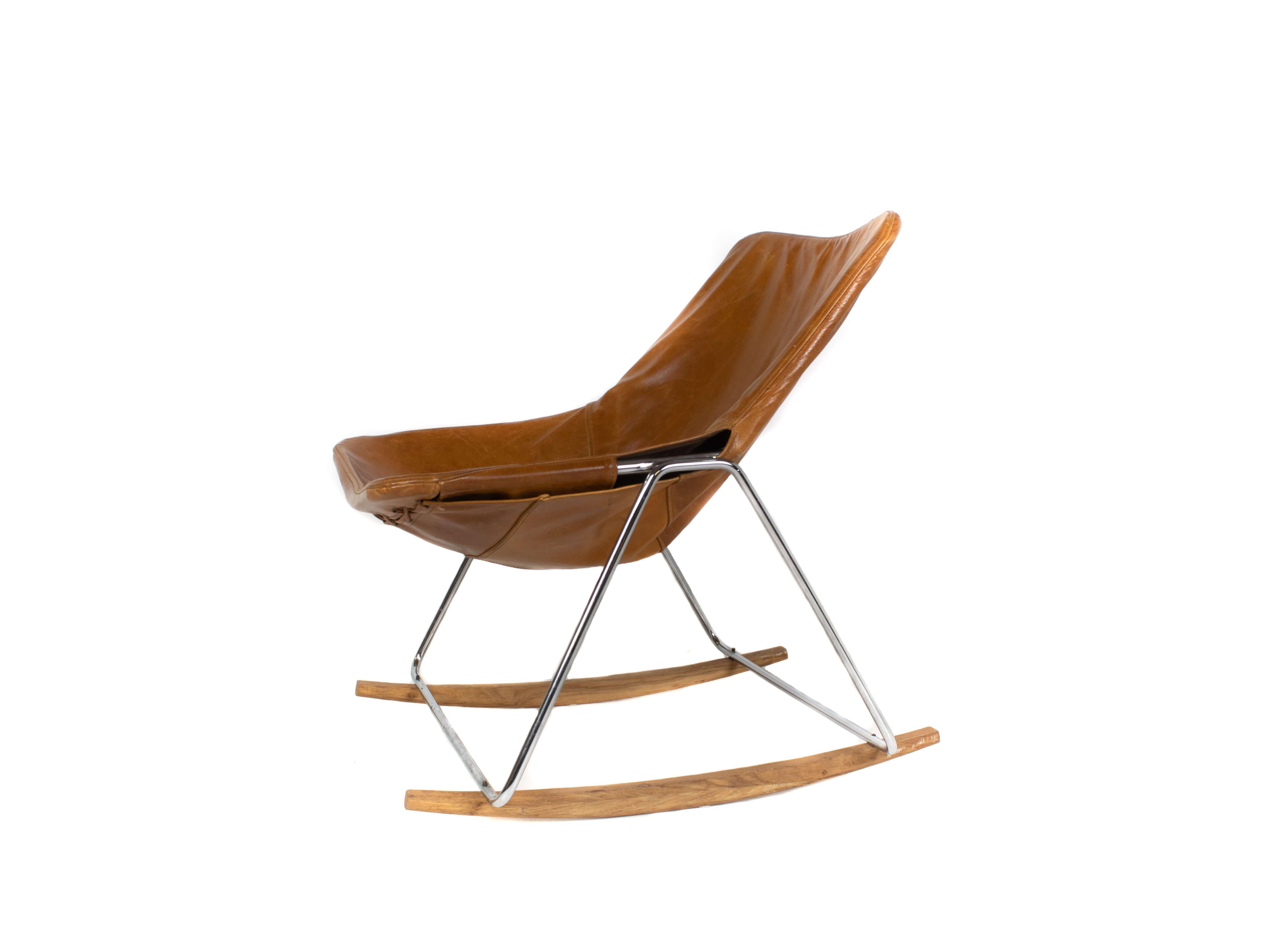 Rare G1 leather rocking chair by Pierre Guariche from France. Designed in the 1950s for Airborne. The simplistic and modern design consist of a tubular steel frame with a seating of cognac leather. Underneath two wooden feet to make this a rocking