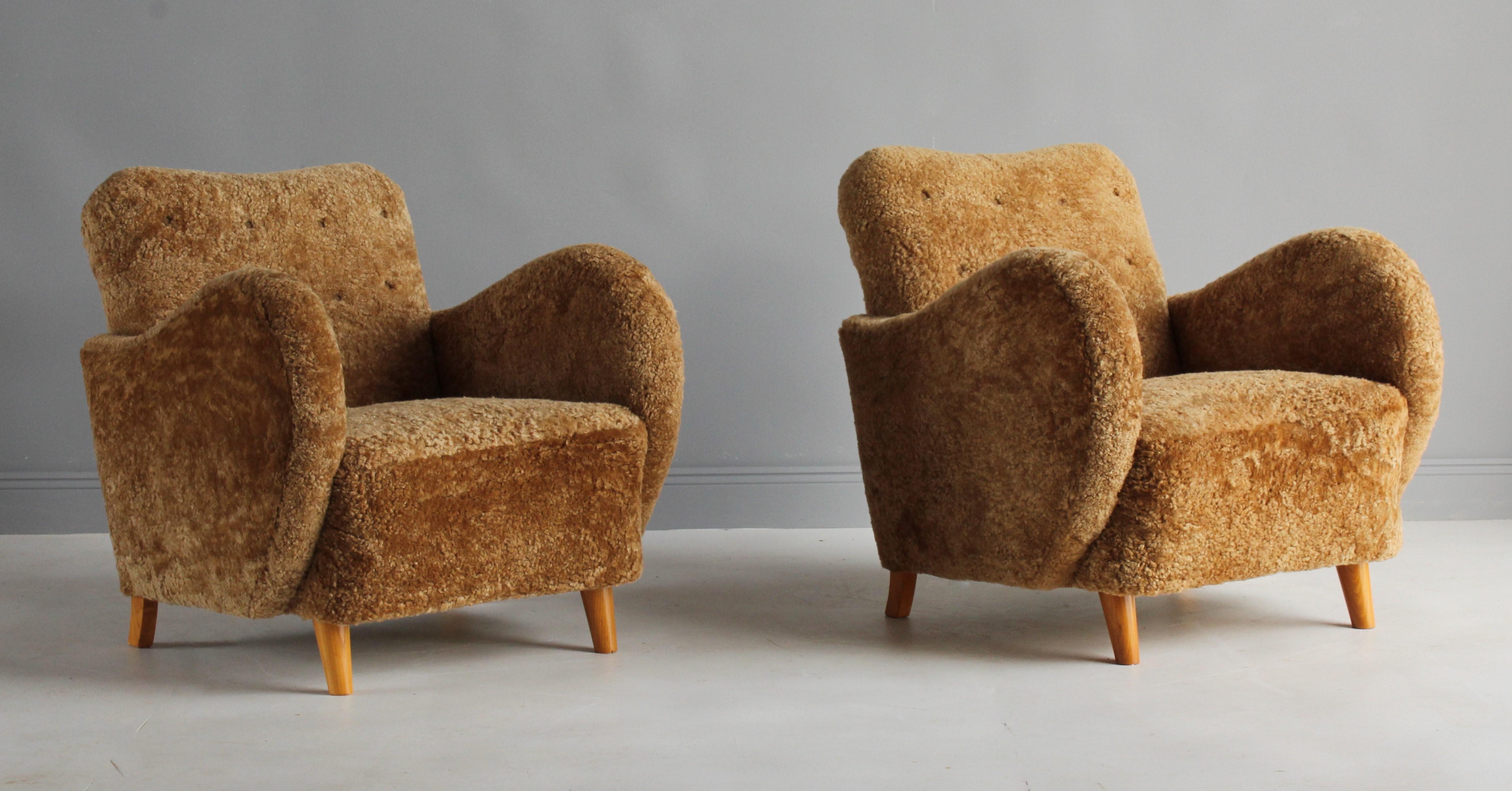 A pair of organic or biomorphic lounge chairs attributed to G.A. Berg. Produced in Sweden, 1930s. Birch legs, reupholstered in authentic deep beige sheepskin or lambskin.

Other designers working in the organic style include Paolo Buffa, Jean