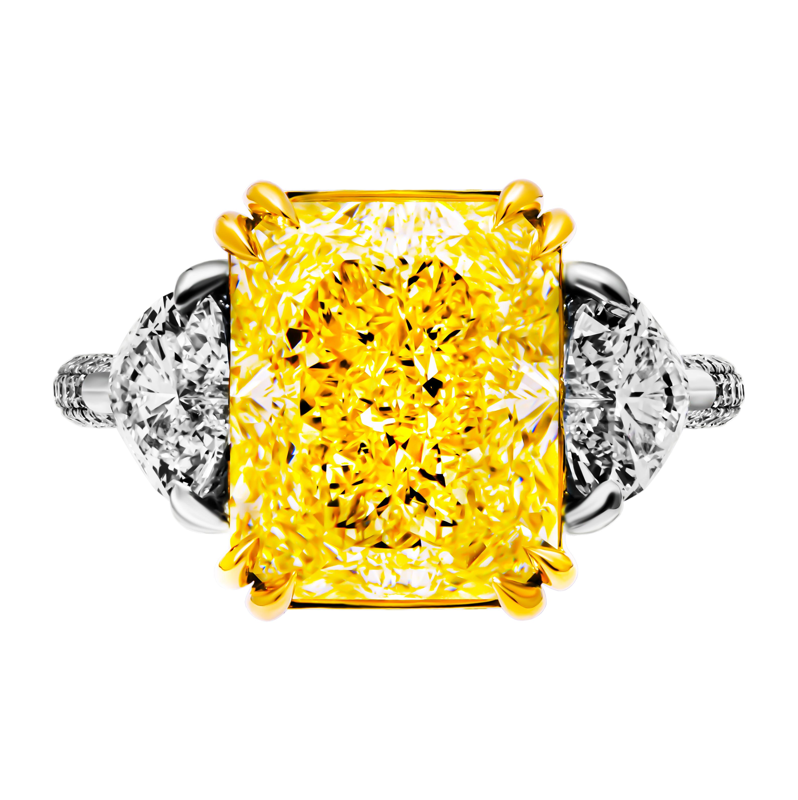 ntroducing an exquisite 3-stone ring, masterfully crafted in a harmonious blend of 18k yellow gold and platinum 950. This luxurious piece showcases a stunning combination of fancy yellow and brilliant white diamonds, meticulously selected for their