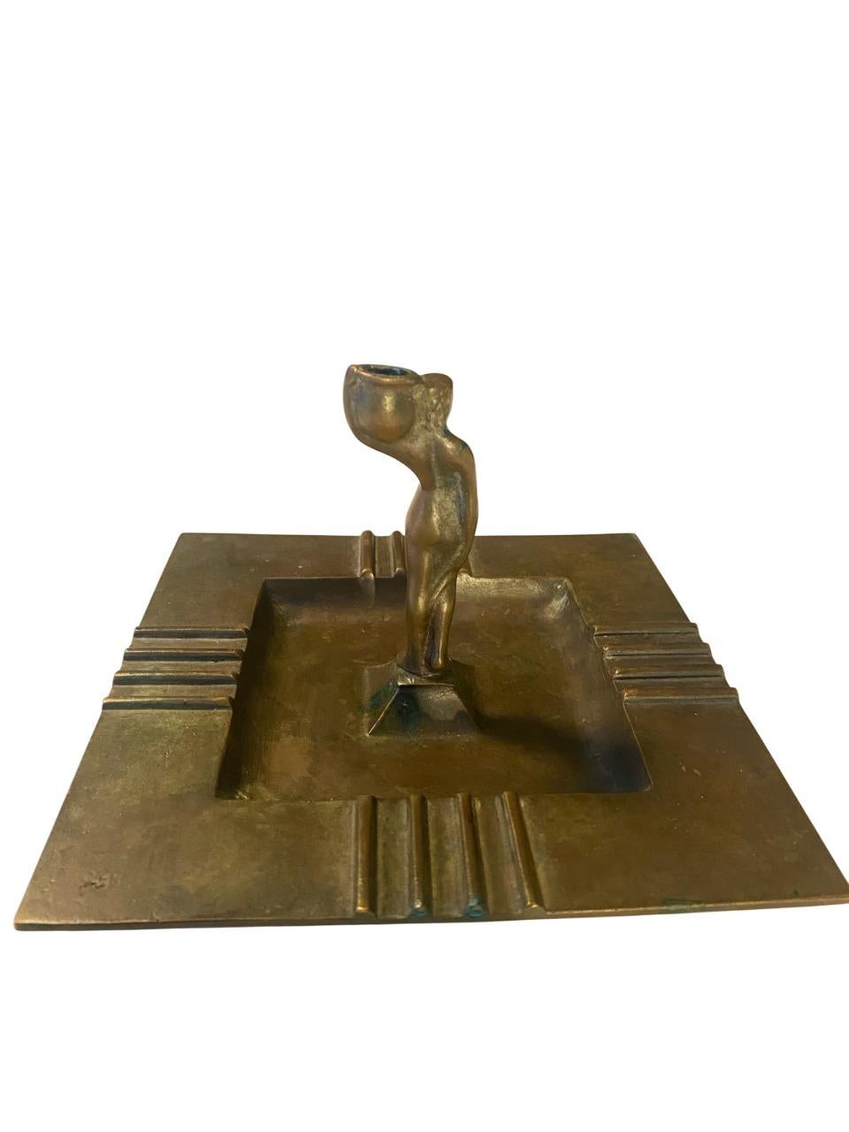 An exceptional and rare Art Deco bronze candleholder/ashtray by Guldsmedsaktiebolaget (GAB), Sweden, dating to the 1930s. This striking piece showcases a stylized female nude figure supporting the candle socket, rising from the center of a geometric