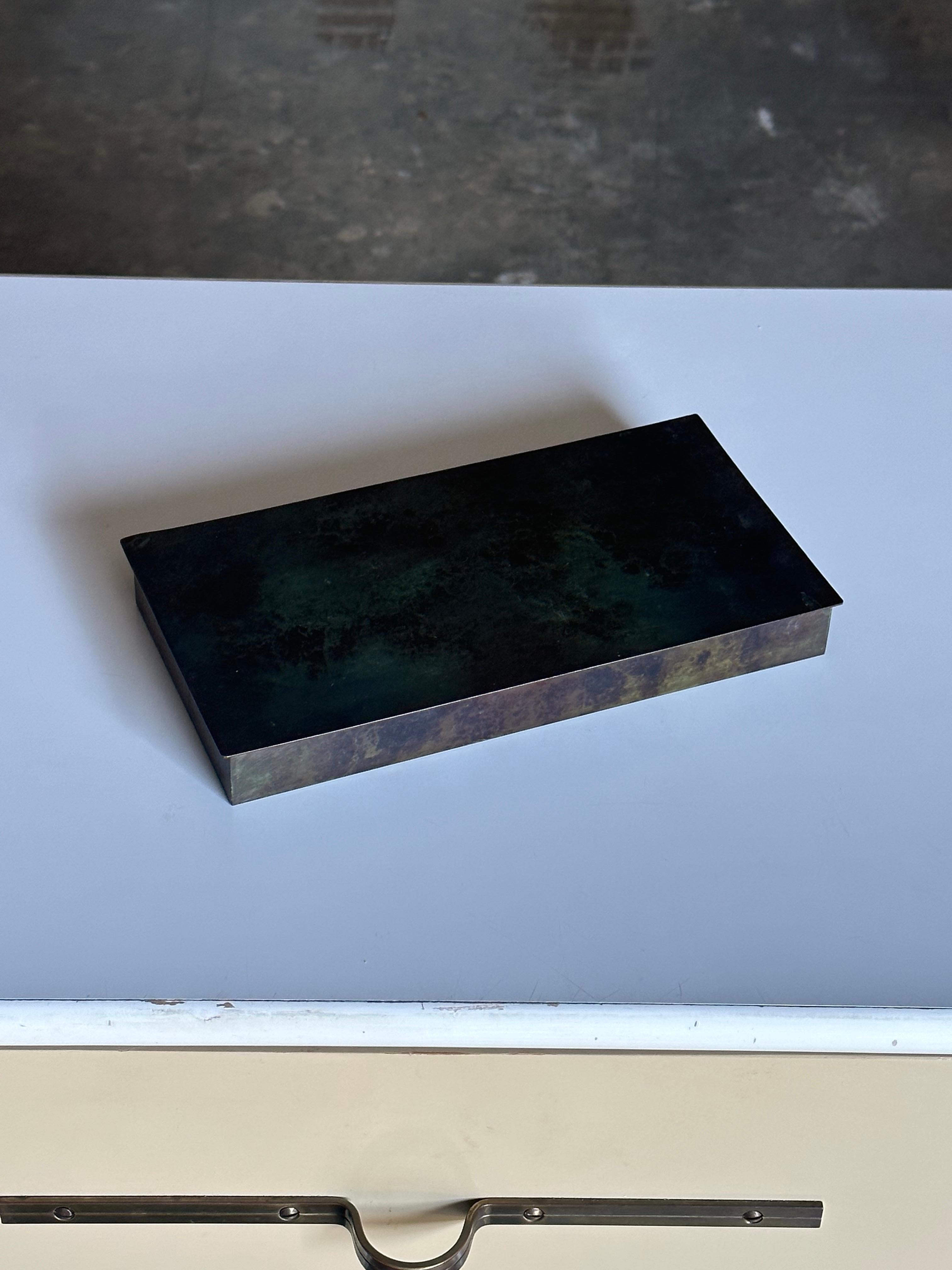 A bronze hinged lid box by GAB, Guldsmedsaktiebolaget. Wonderful patina with the bronze showing a greenish effect throughout. Great Art Deco styling. Could be used as a jewelry or pencil box.