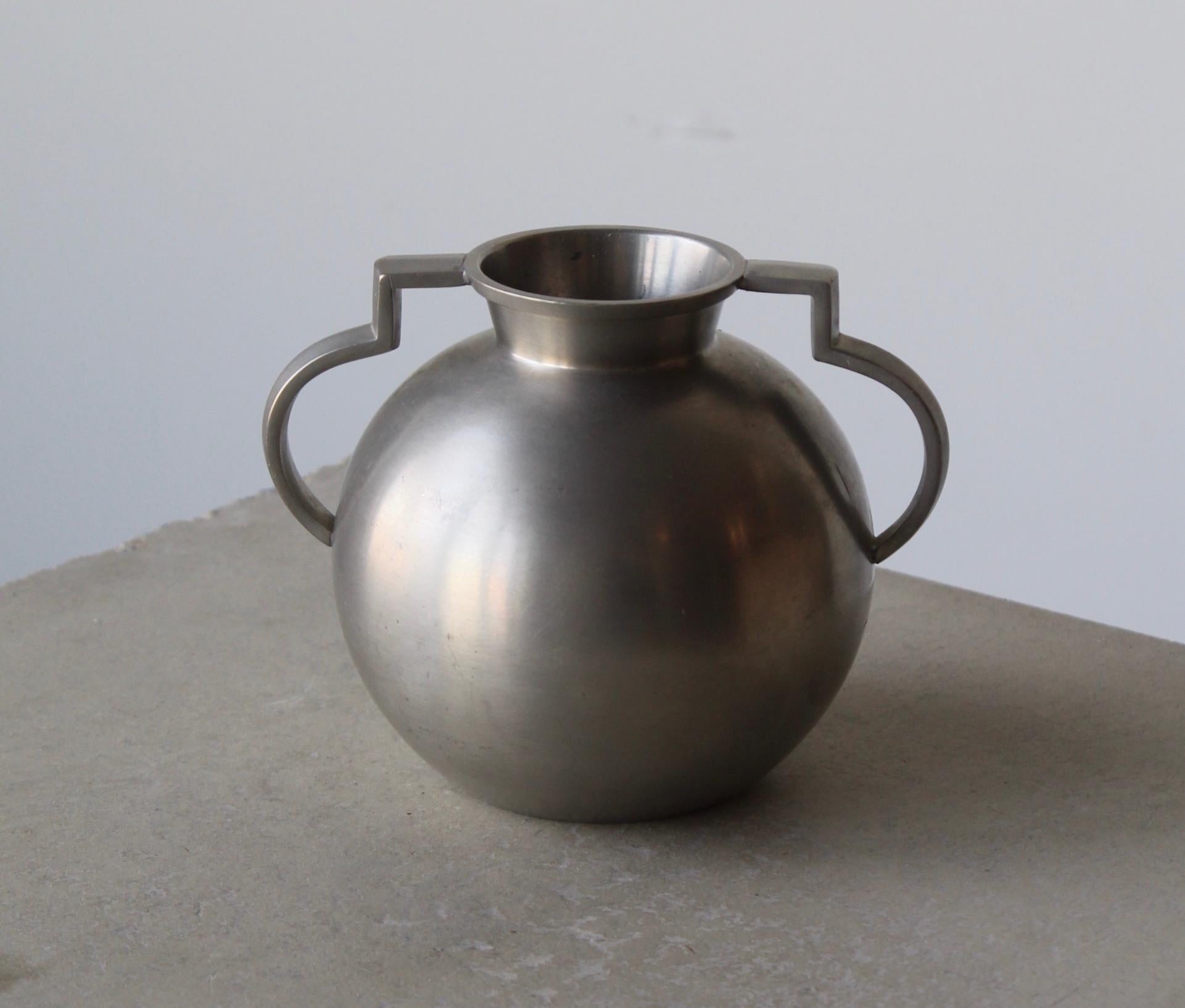 A vase or vessel or trophy, produced by GAB, stamped with makers mark, Sweden. In cast pewter.

Other designers of the period include Josef Frank, Kaare Klint, Estrid Ericson, and Just Andersen.
   