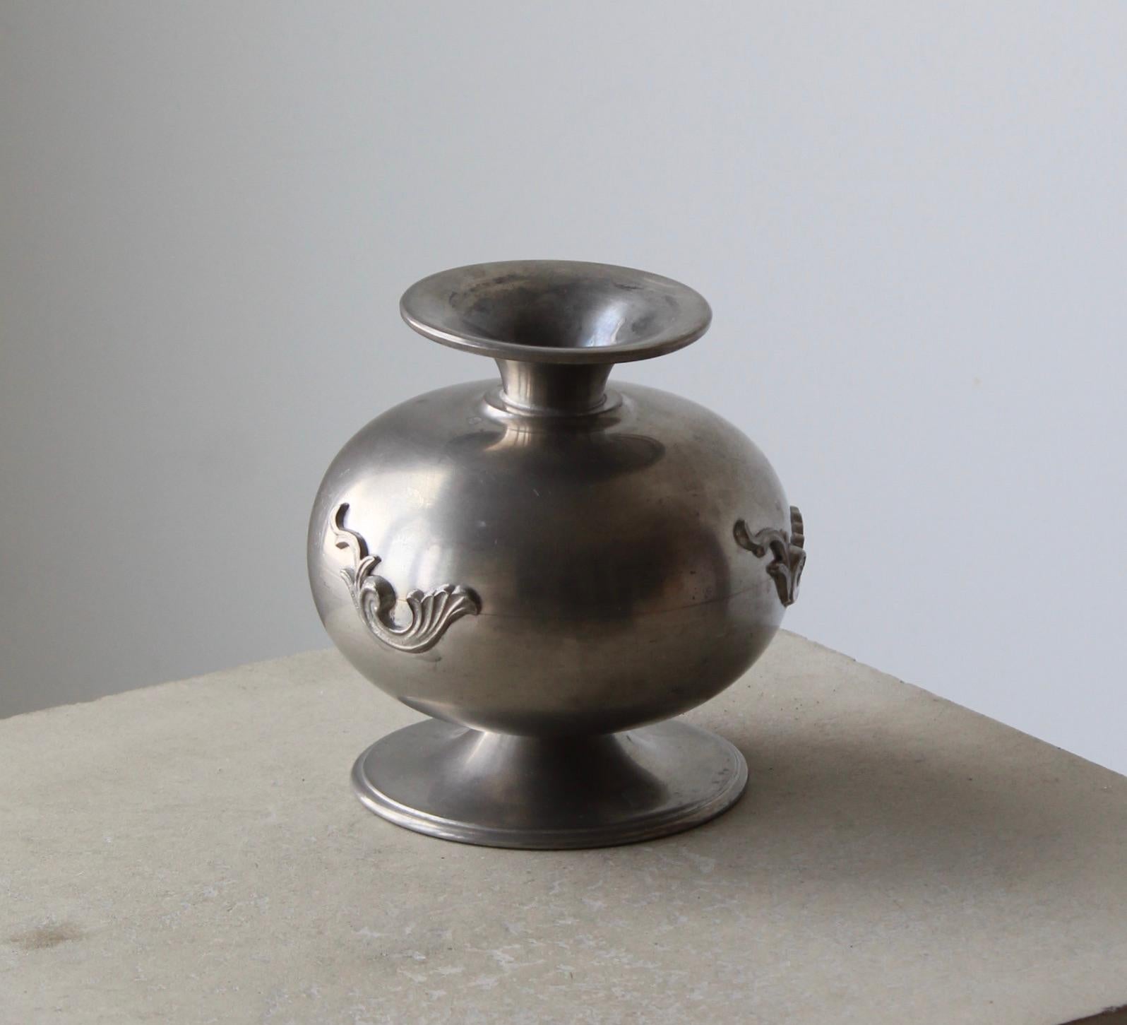 A vase or vessel, produced by GAB, stamped with makers mark, Sweden. In cast pewter. 

Other designers of the period include Josef Frank, Kaare Klint, Estrid Ericson, and Just Andersen.
 